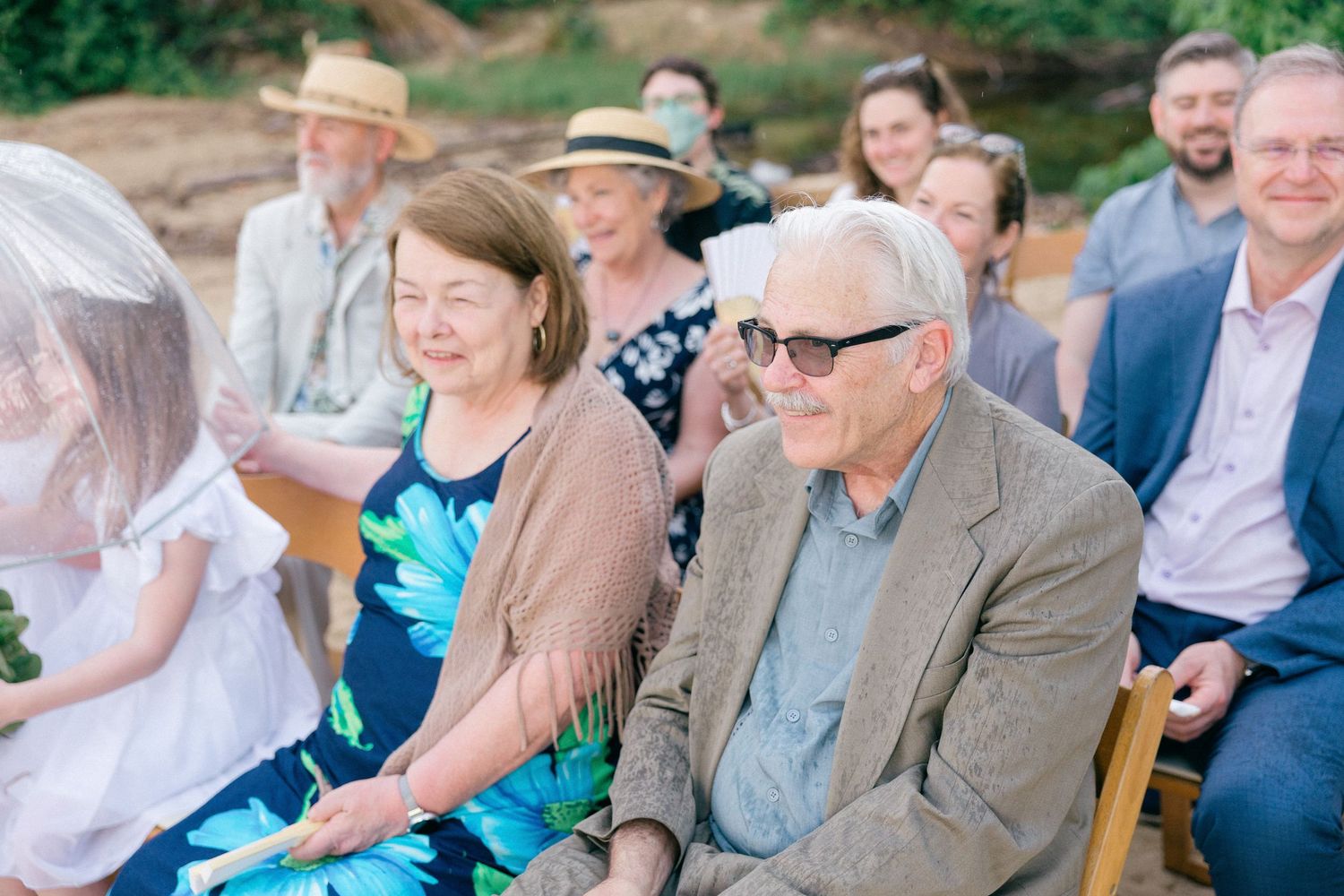 Wedding guests seated outdoors enjoying the ceremony celebrations.