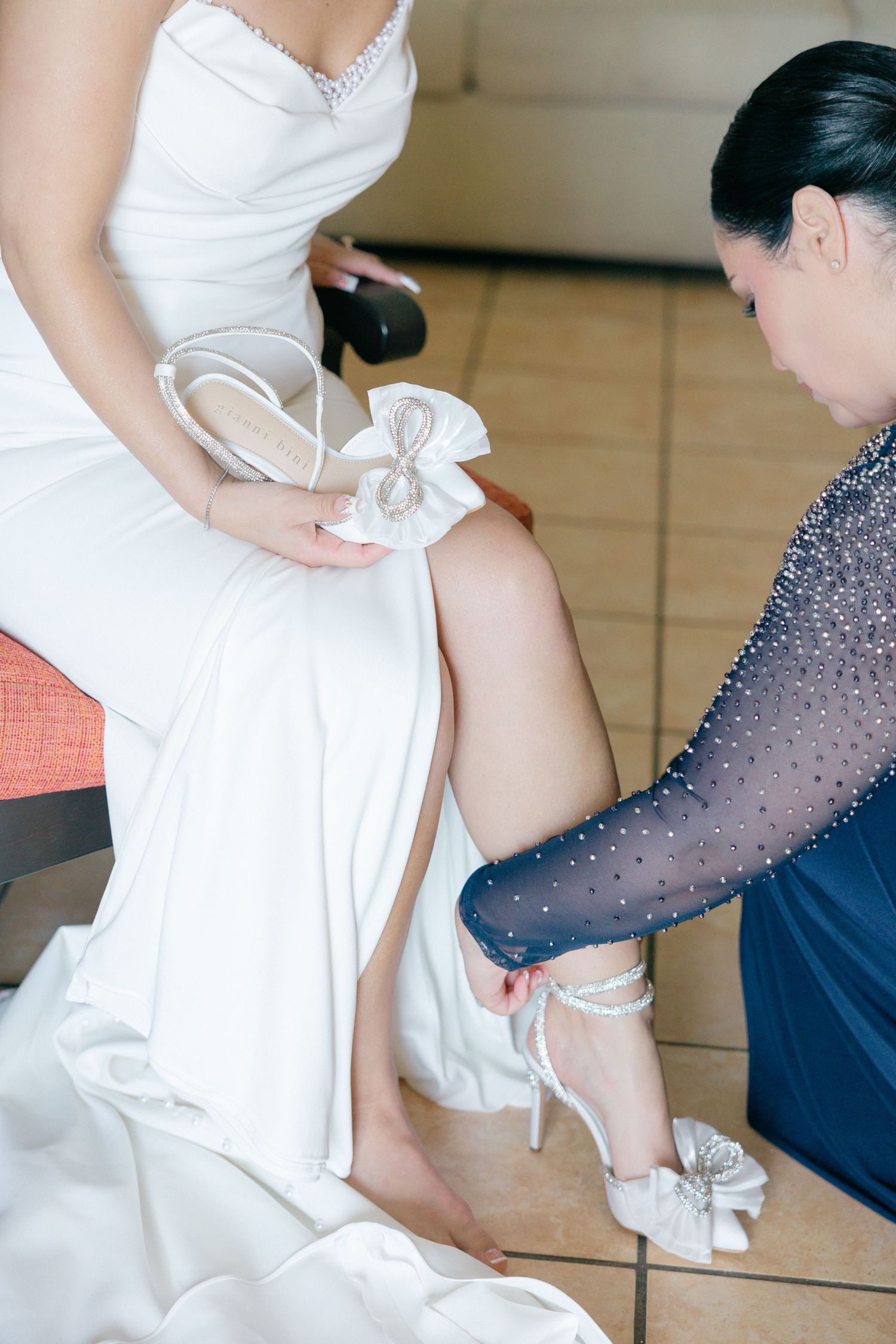 Wedding dress fitting session showing detailed lace and beadwork.