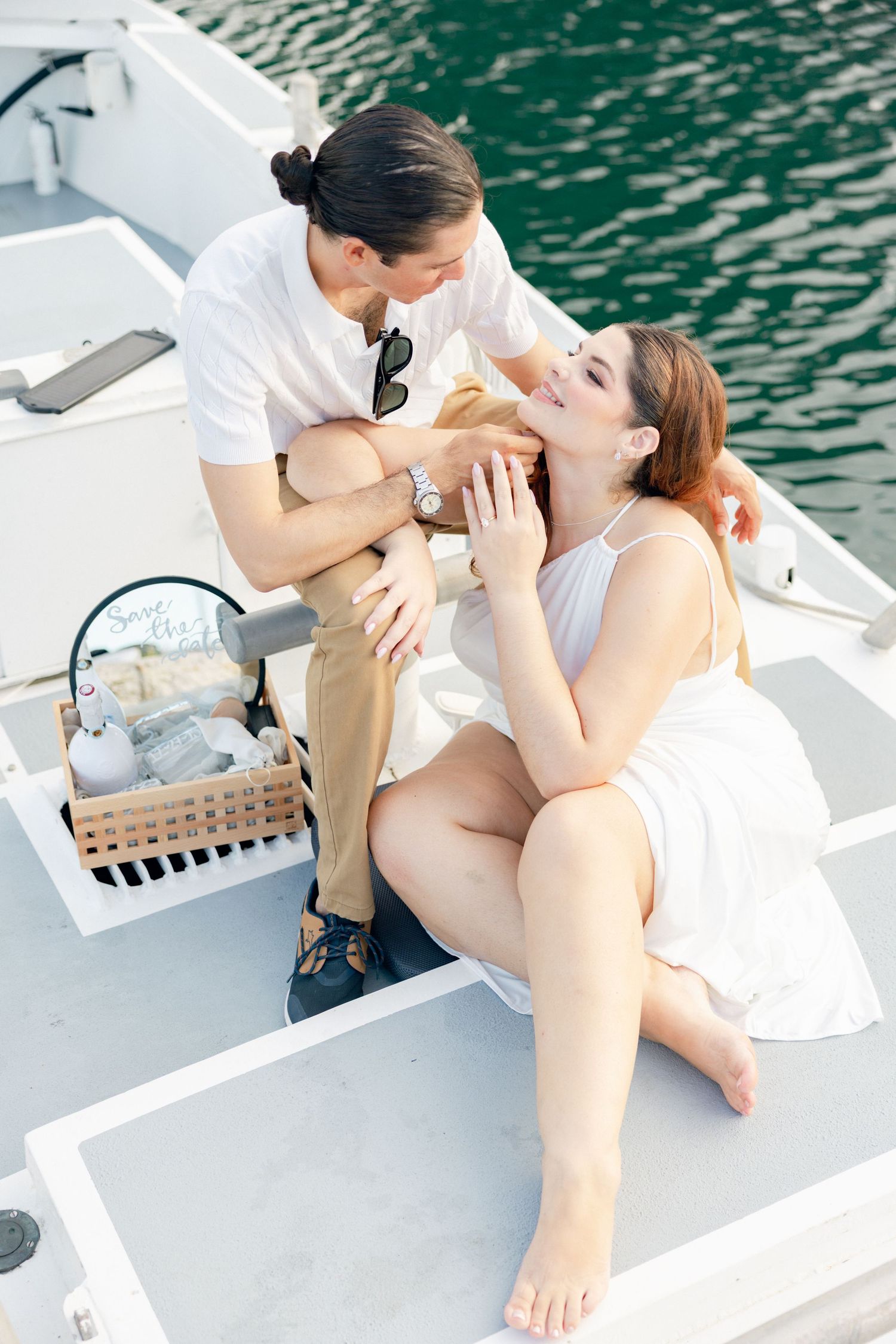 Intimate couple sharing romantic moments on a boat deck.