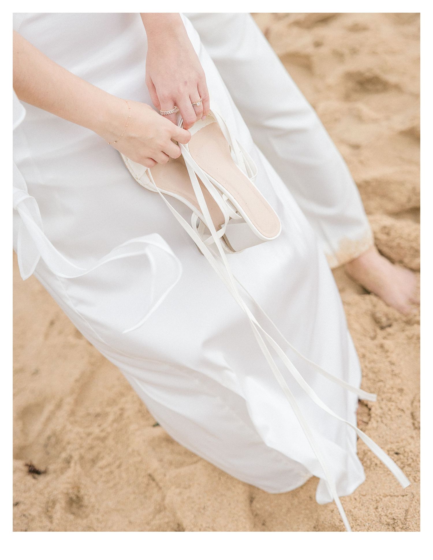 Detail shots of white formal wear and bare feet in beach sand.