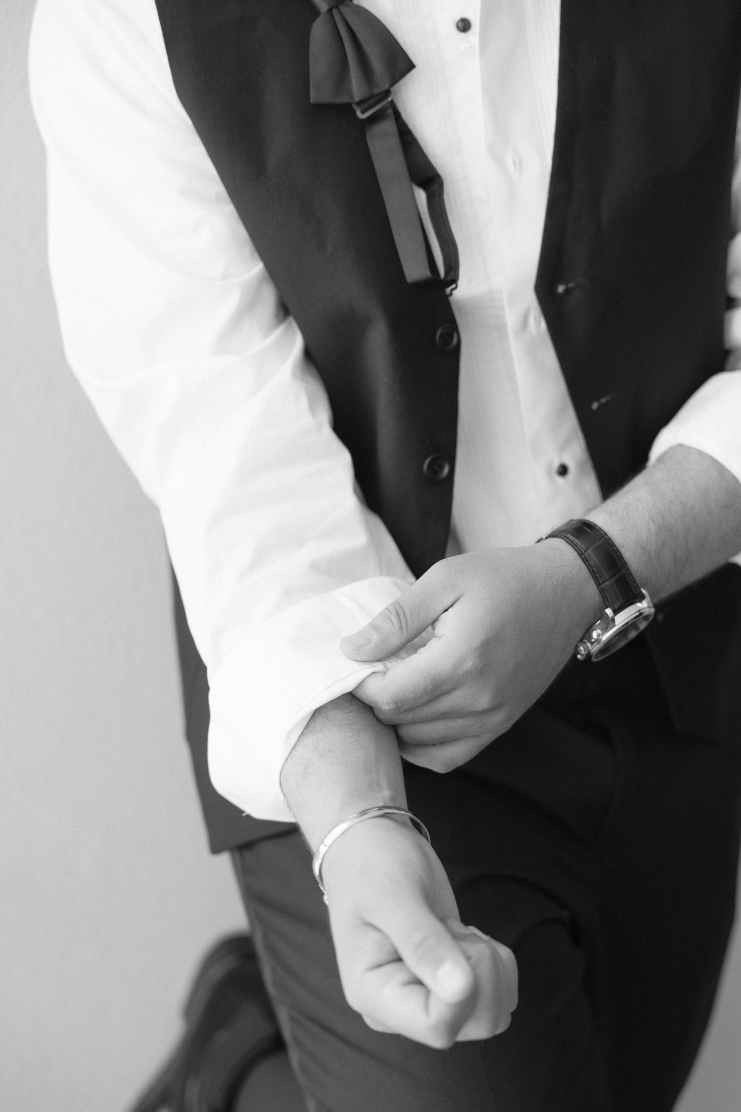 Close-up shots of formal wear details including buttons and vest adjustments.