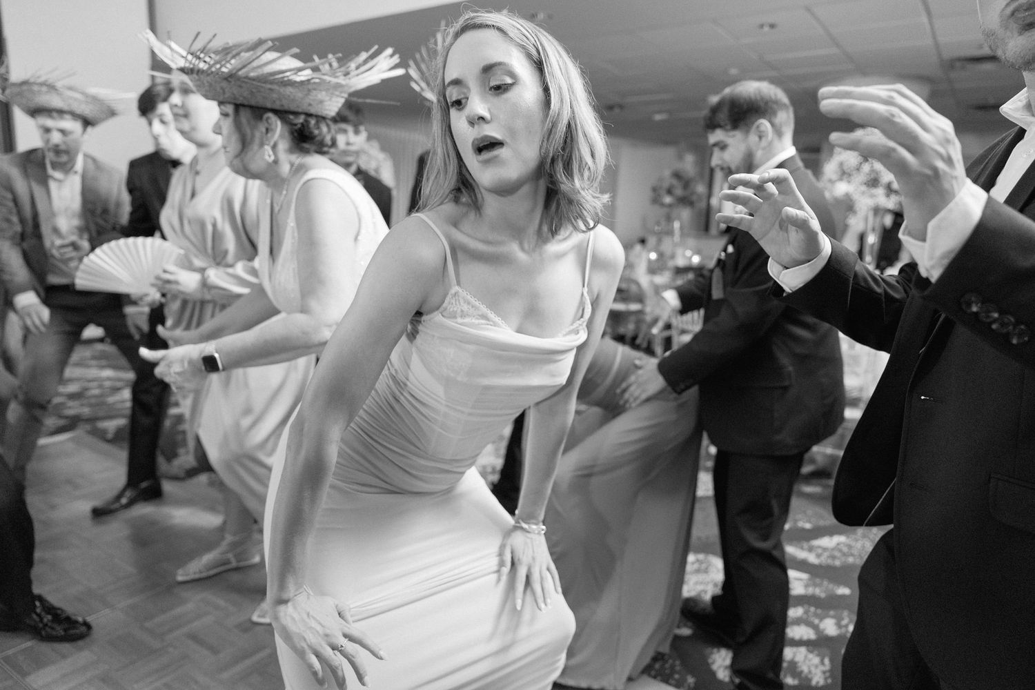 Candid shots of wedding guests dancing and enjoying themselves at the reception.