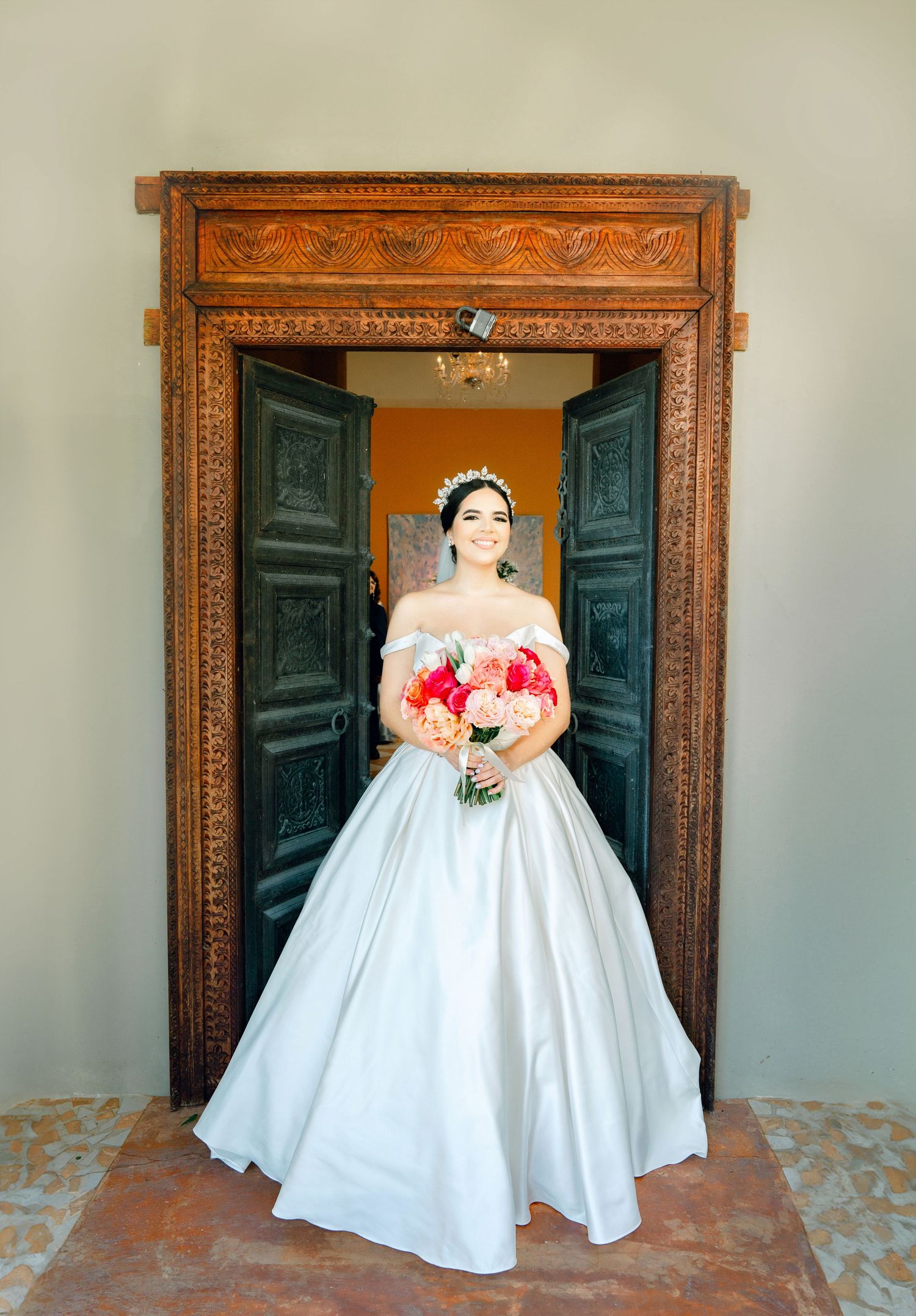Sequence of bridal portraits in front of ornate wooden doors showing full ballgown wedding dress.