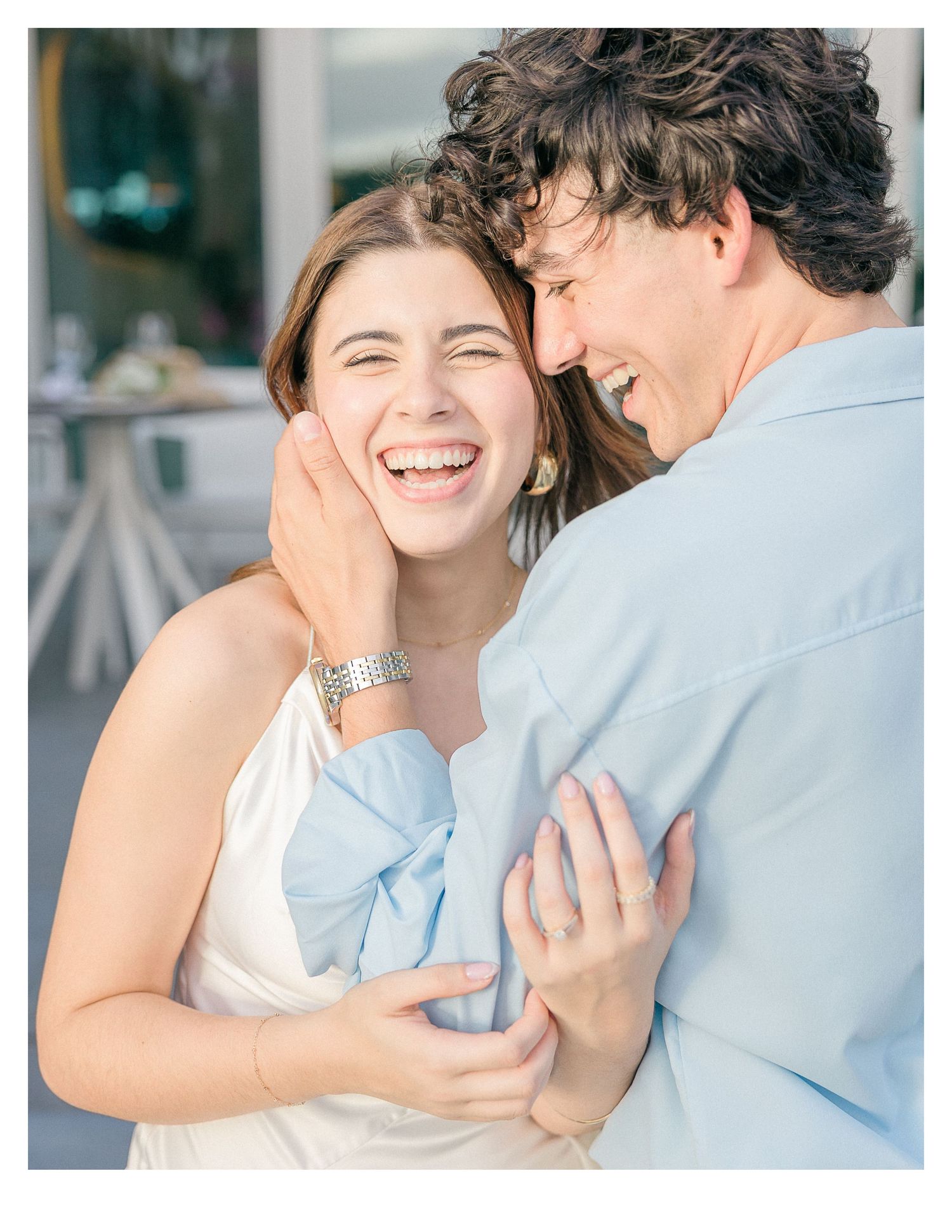 A joyful couple sharing a tender moment in casual attire.