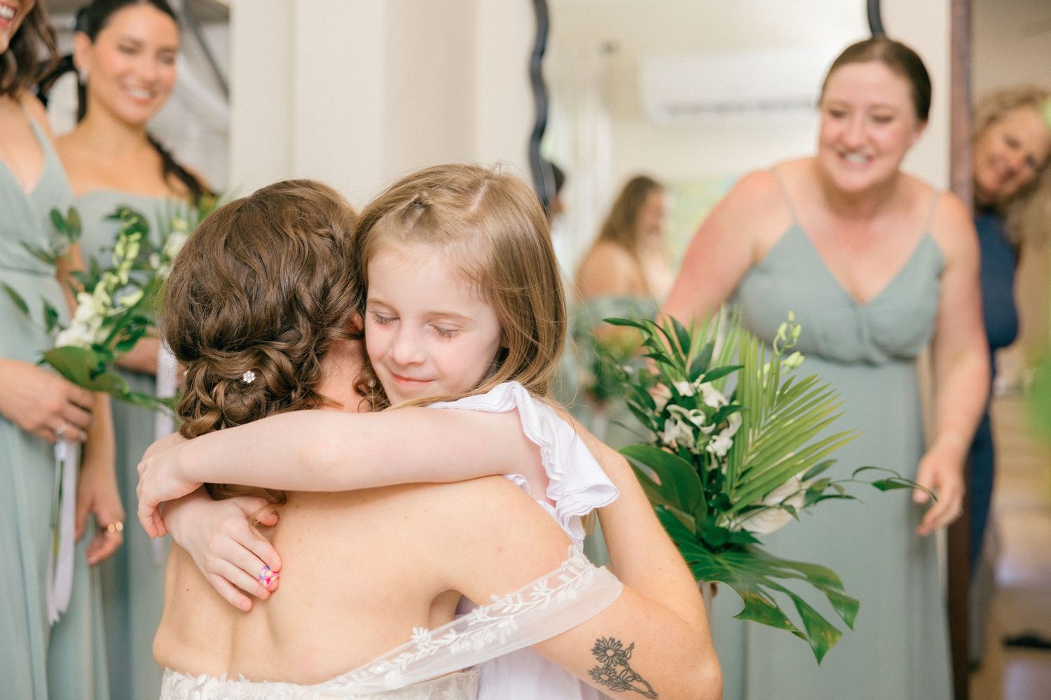 Touching embrace shared between bridal party members during wedding preparations.