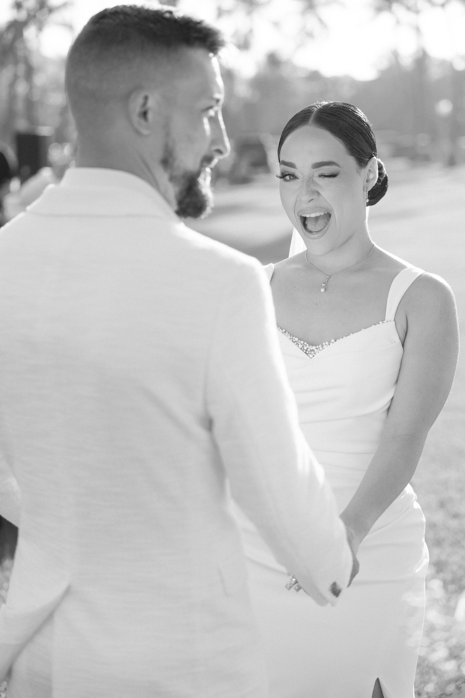 Intimate black and white wedding photo capturing romantic moments during the ceremony.