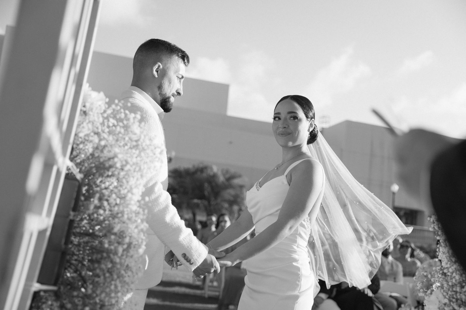 Black and white wedding ceremony moments captured under elegant decor.