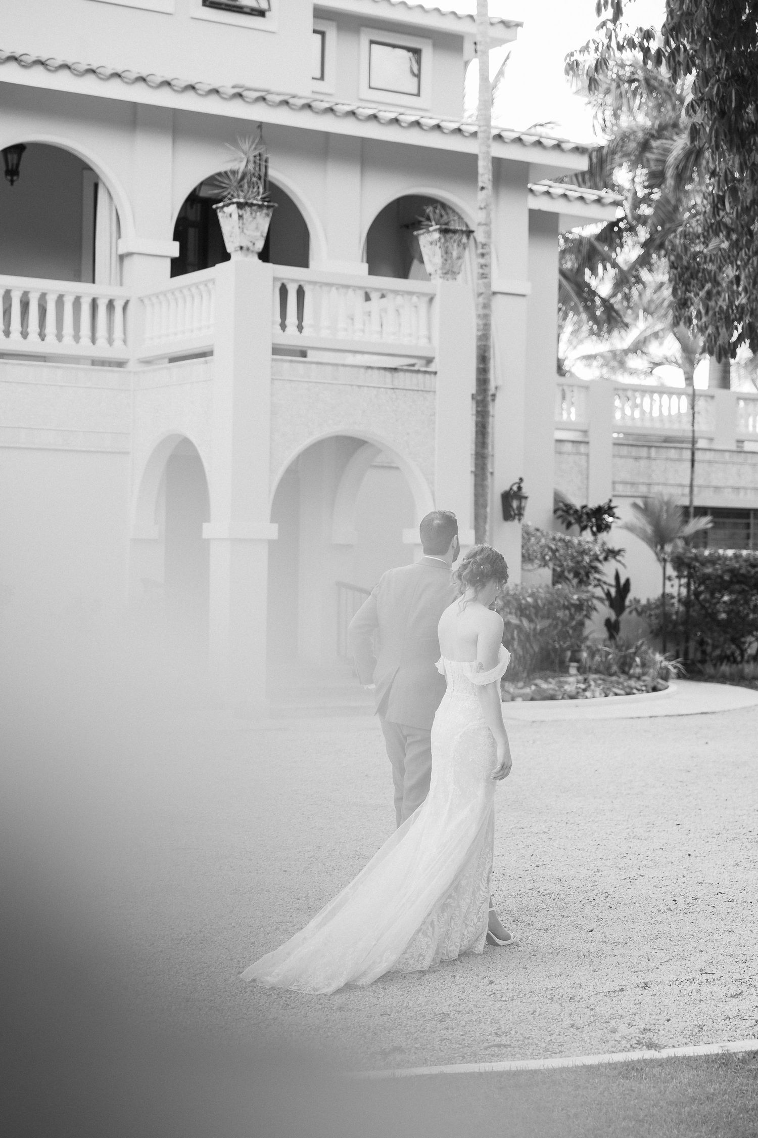 Ethereal black and white wedding photos showing a flowing white dress against classic white architecture.