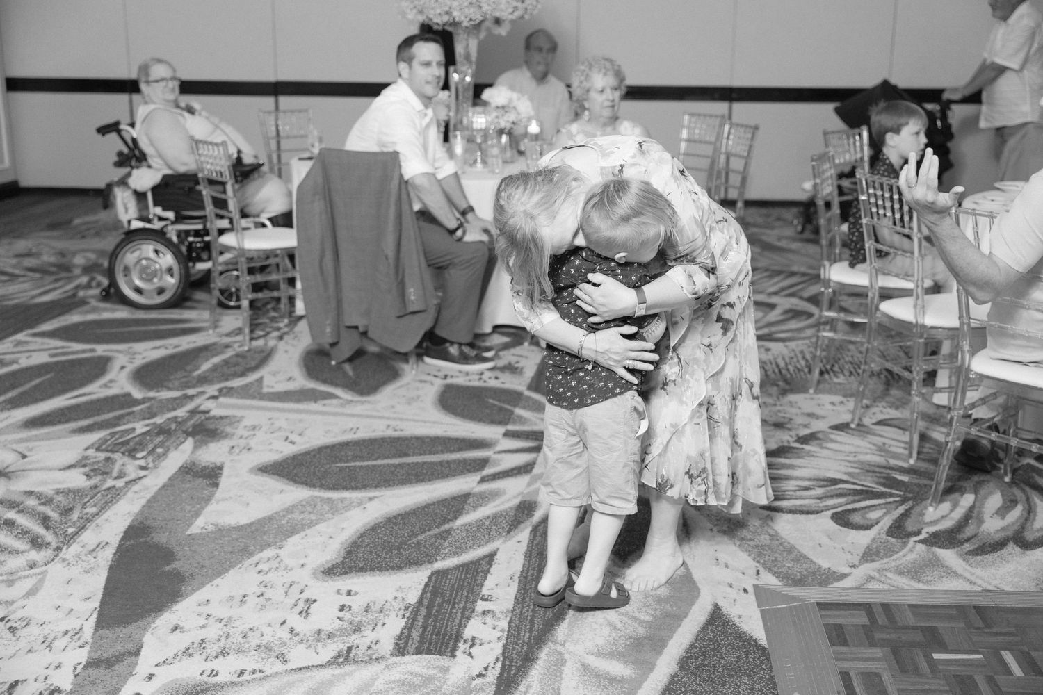 People dancing and having fun at an indoor wedding reception celebration.