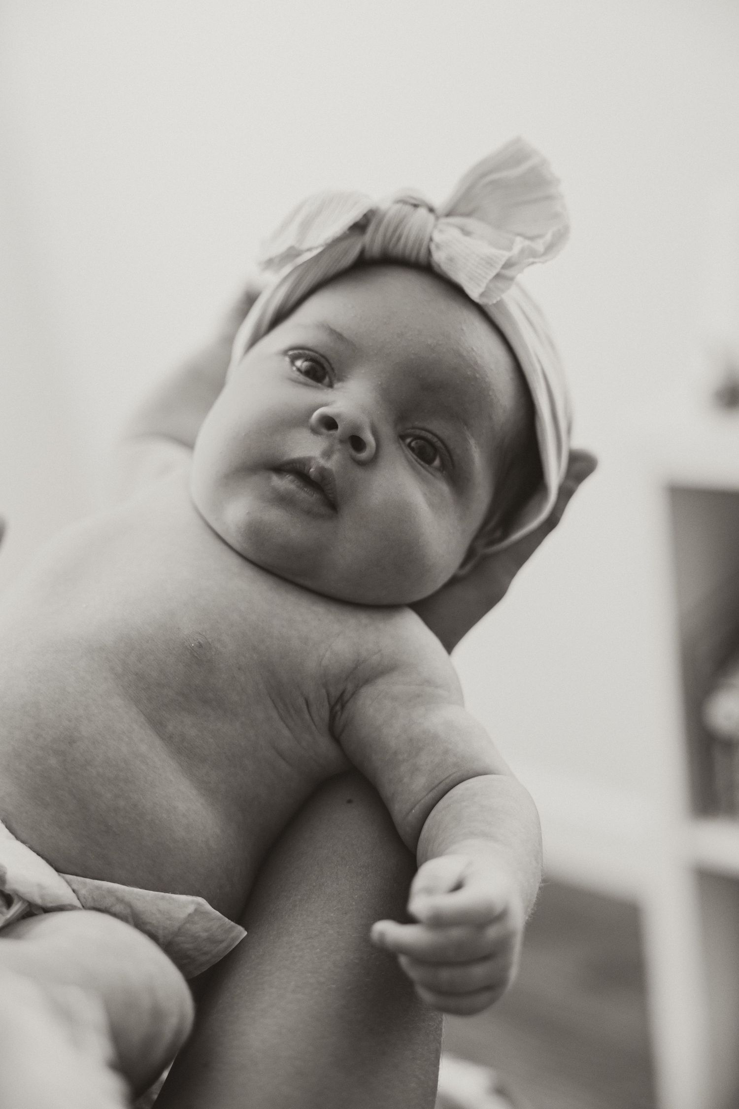 Series of black and white close-up shots showing a baby's face with a gentle expression.