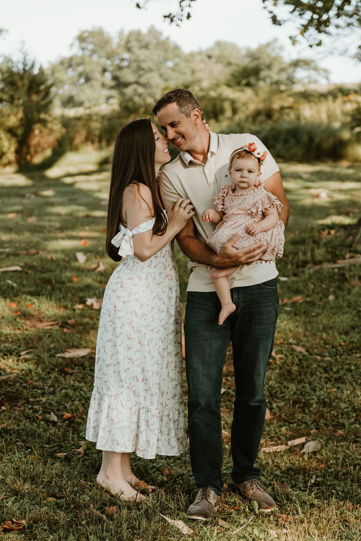 Family portrait session in park during golden hour.