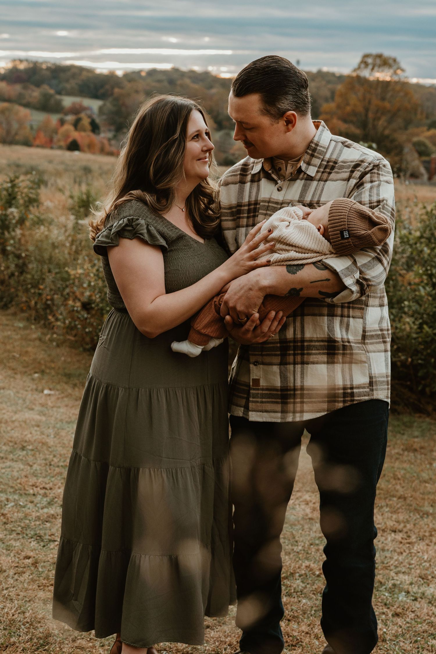Family sharing tender moment together outdoors during fall season.