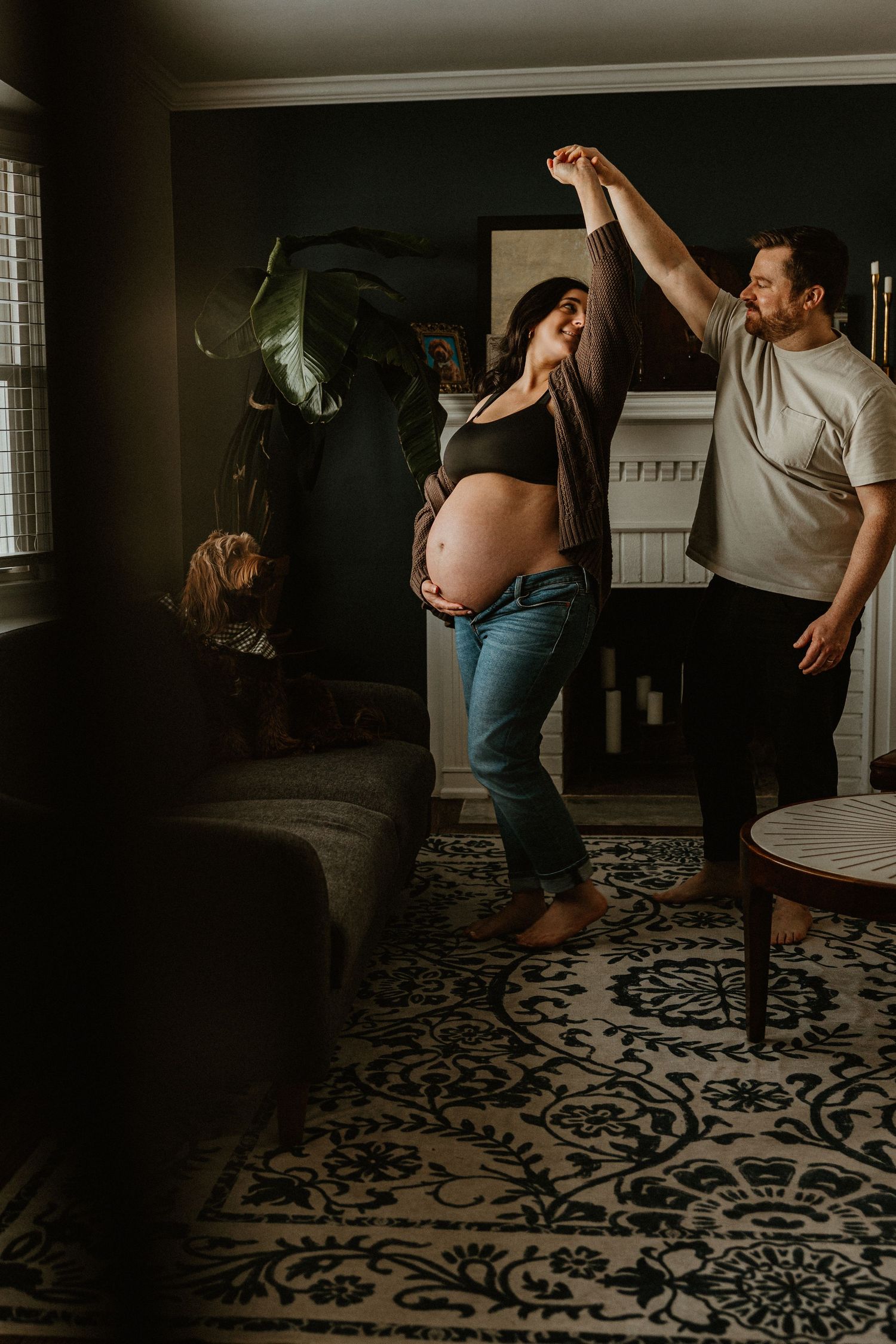 Couple dances together on decorative floor during intimate indoor photo session.