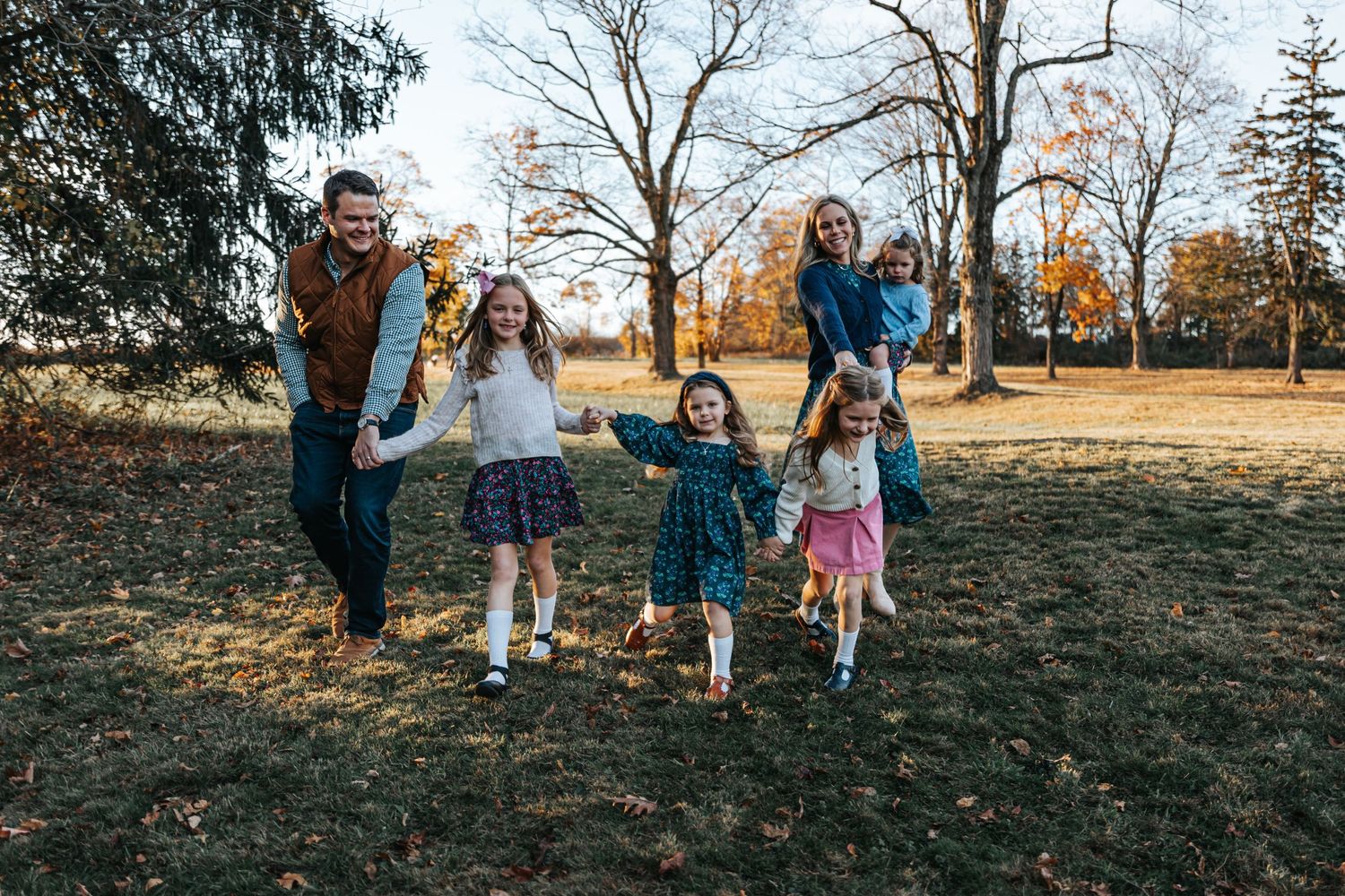 Group walking together on a wooded path during fall season.