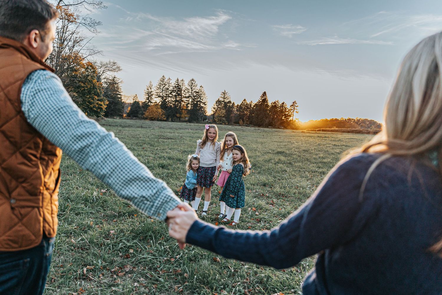 Panoramic views of a family enjoying outdoor activities in a sunlit meadow.