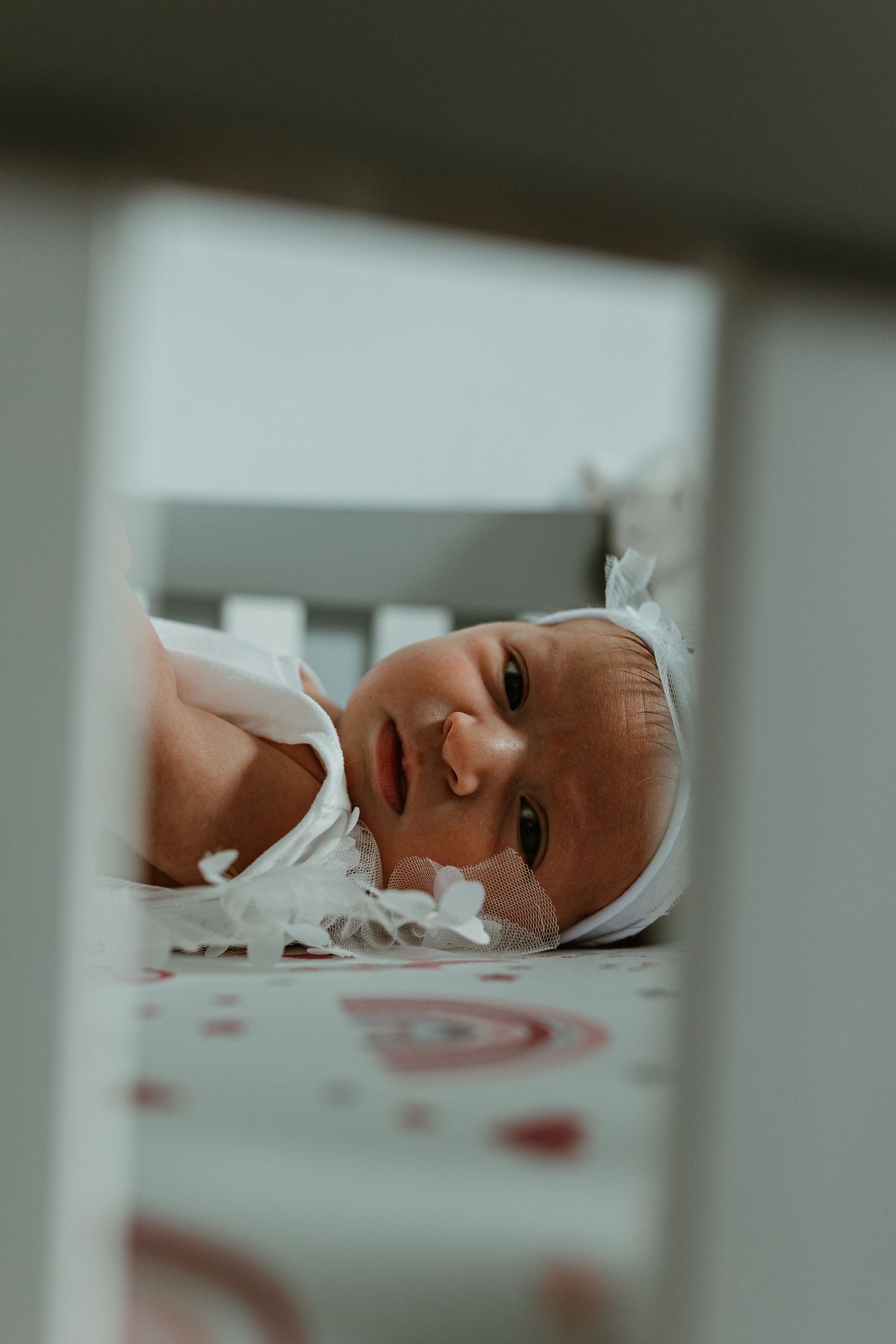 Close-up view of a sleeping newborn baby in soft lighting.