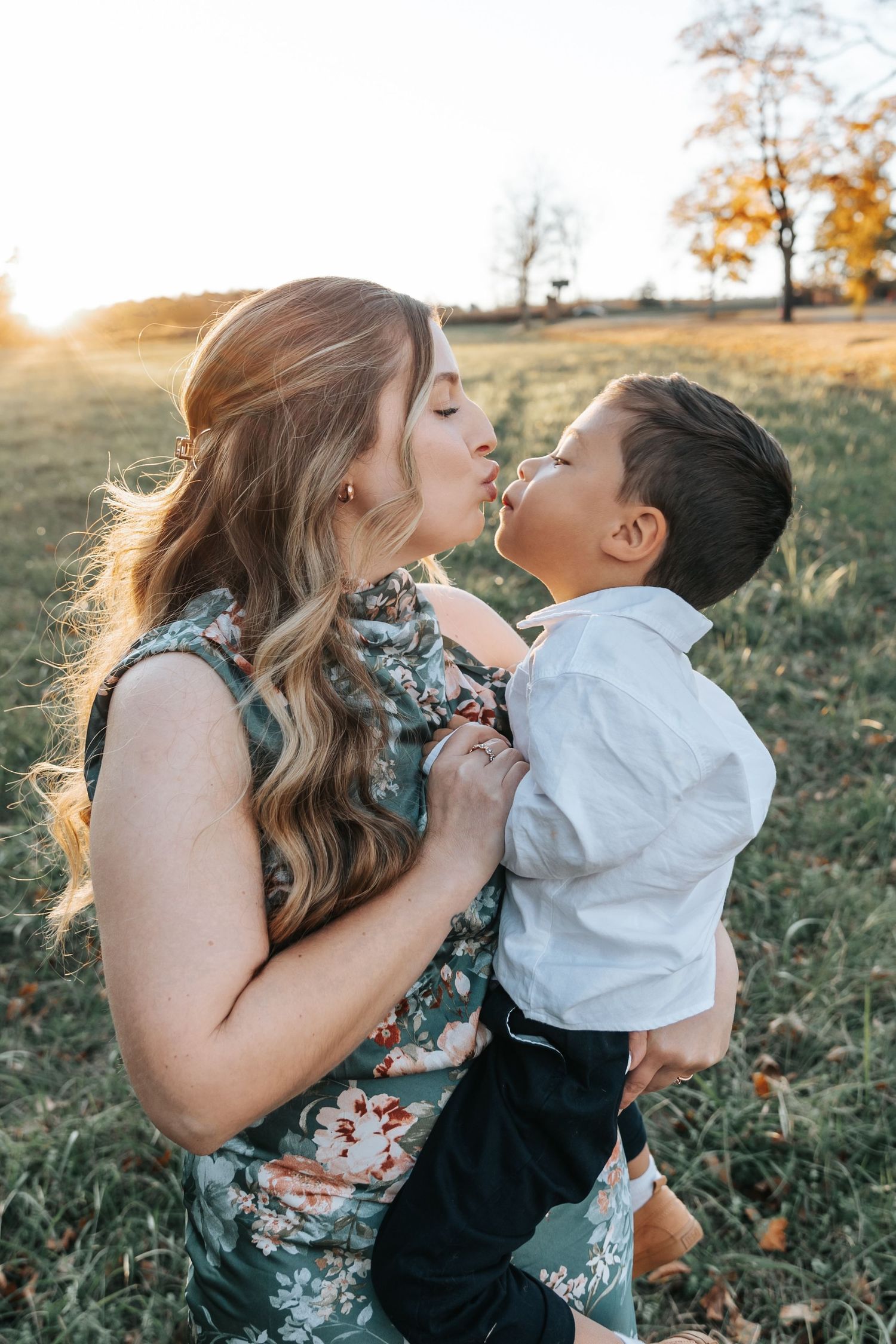Sweet candid moments captured between family members during an outdoor photo session.