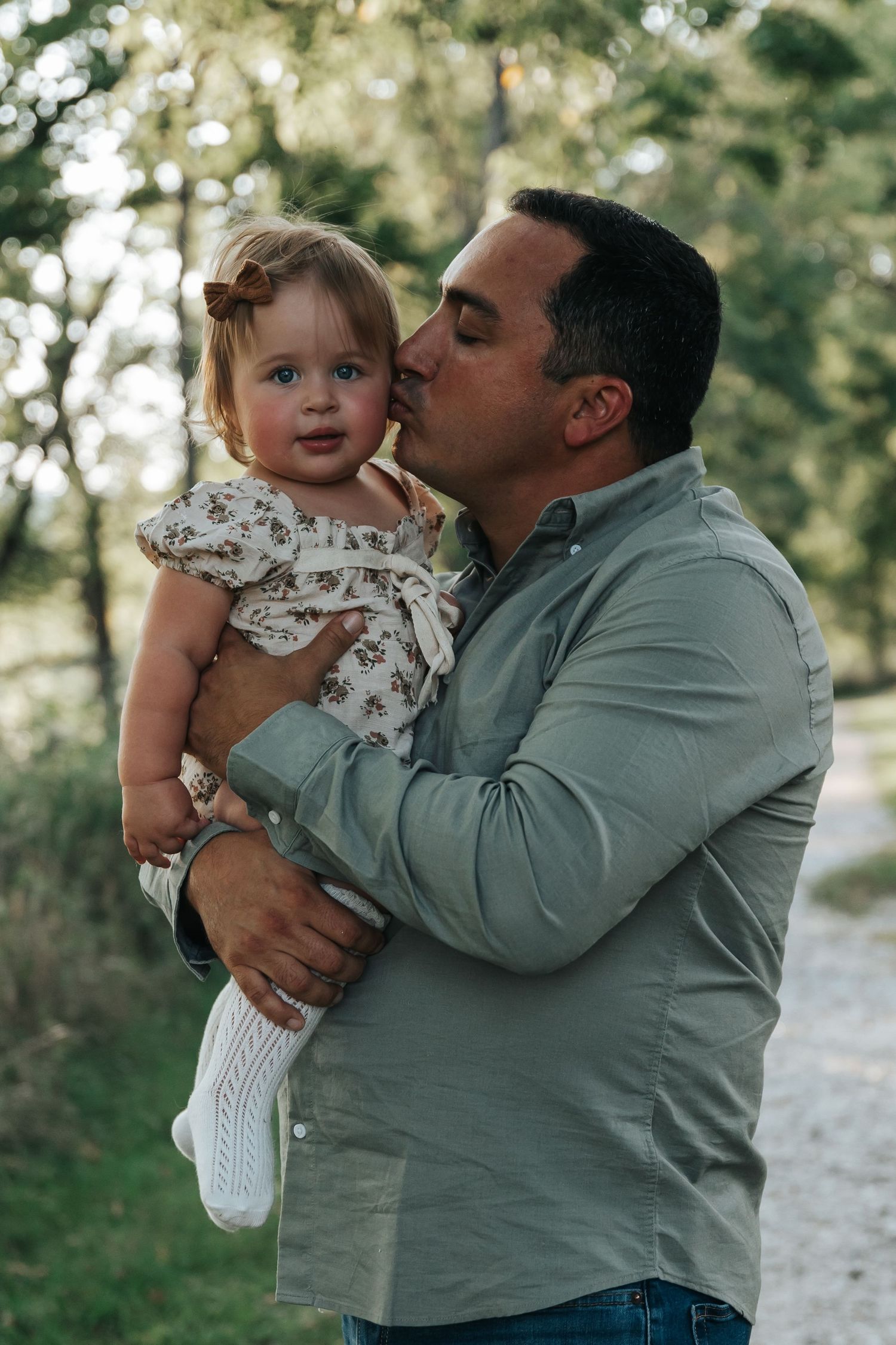 Tender family moments shared on a sunlit path.
