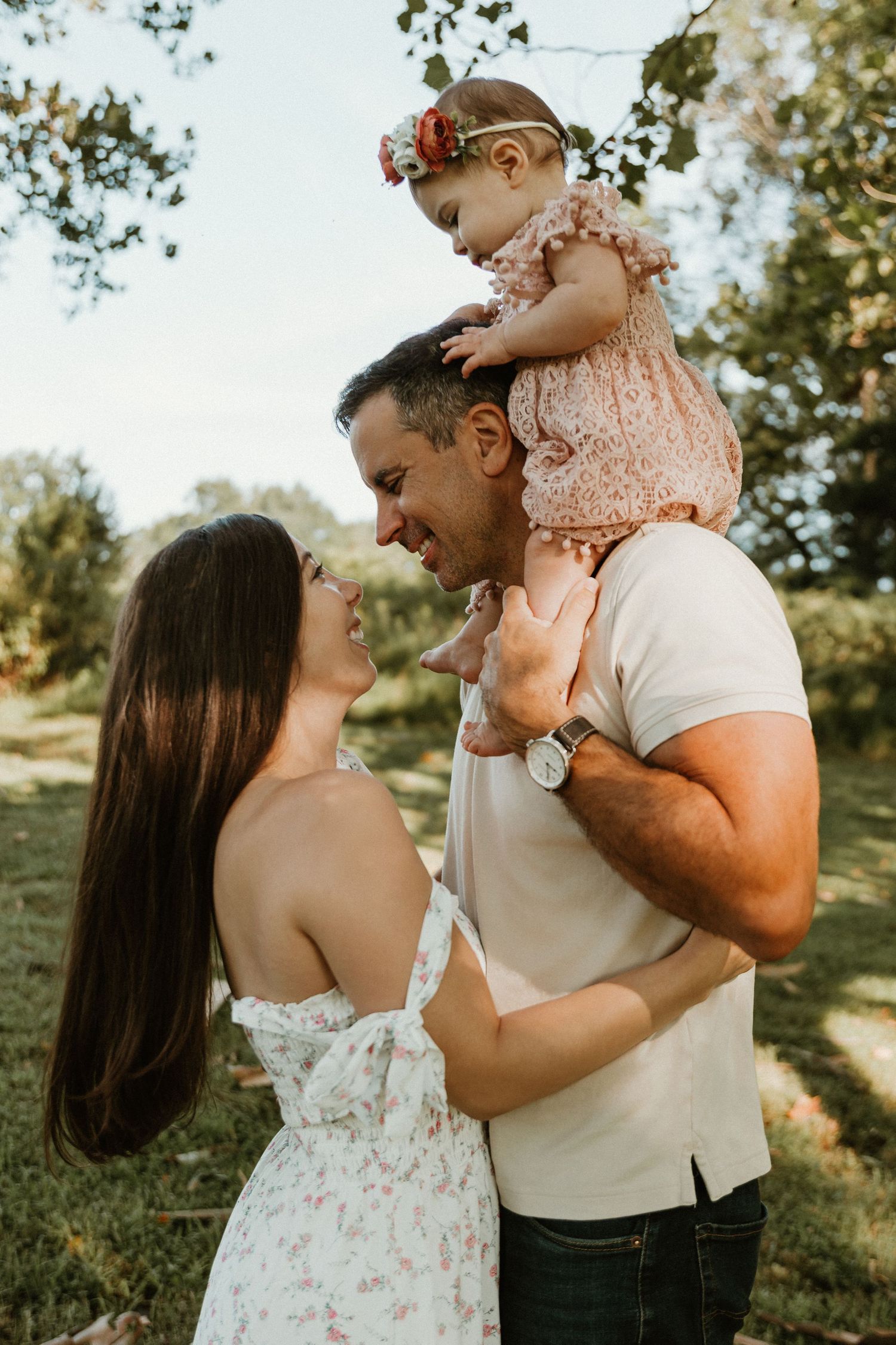Family sharing intimate moments together outdoors during photo session.