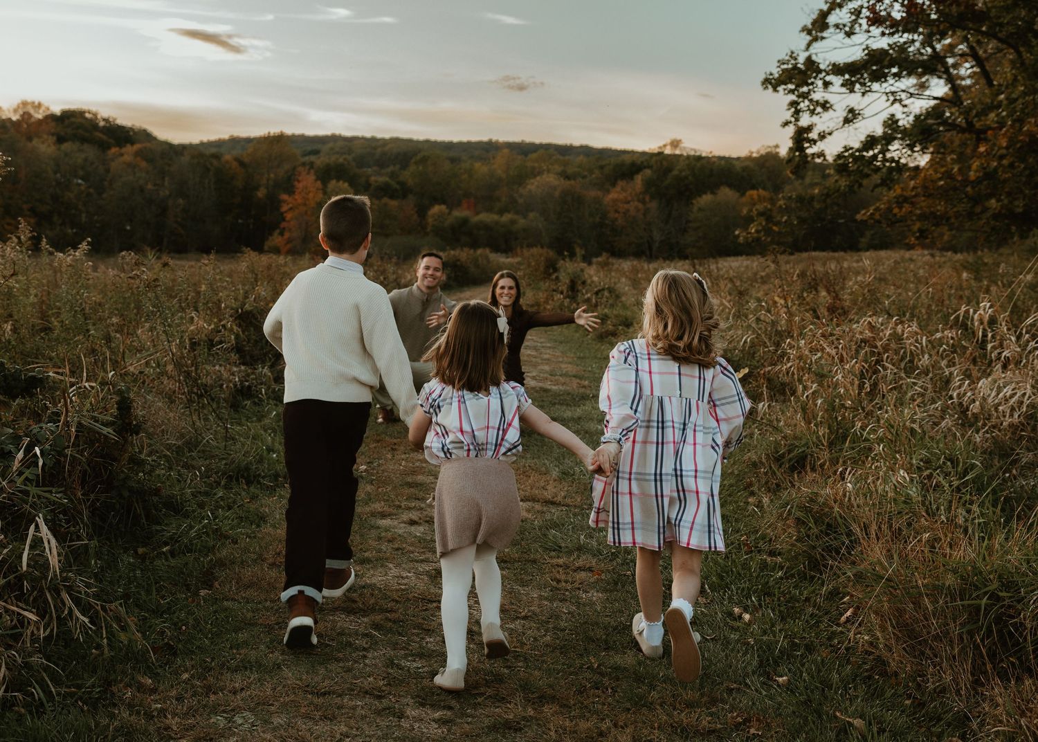 Group walking together along a scenic path during golden hour.