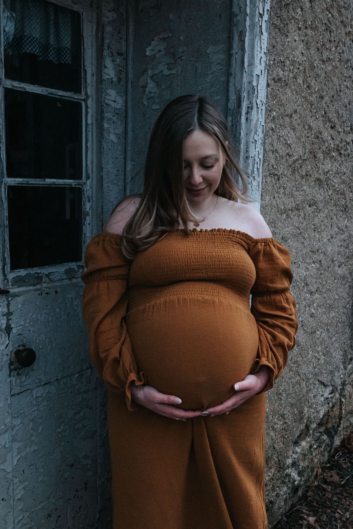 A sequence of maternity photos featuring a brown dress against a rustic wall backdrop.