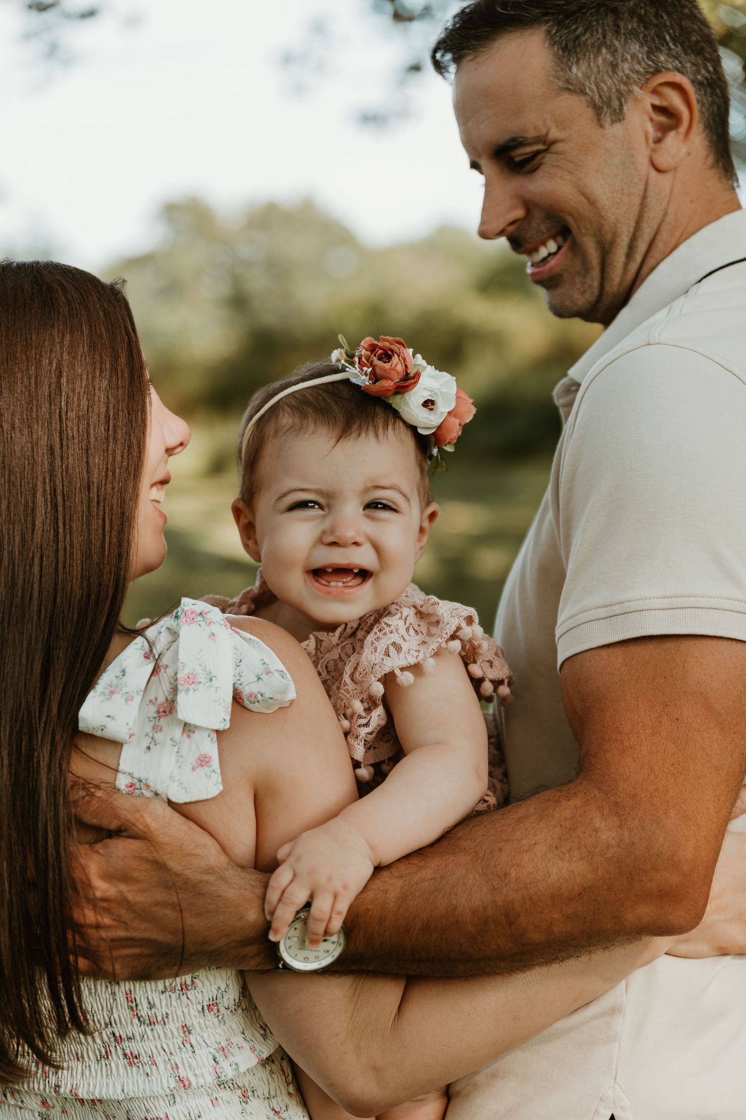 Candid family moments captured during outdoor photo session.
