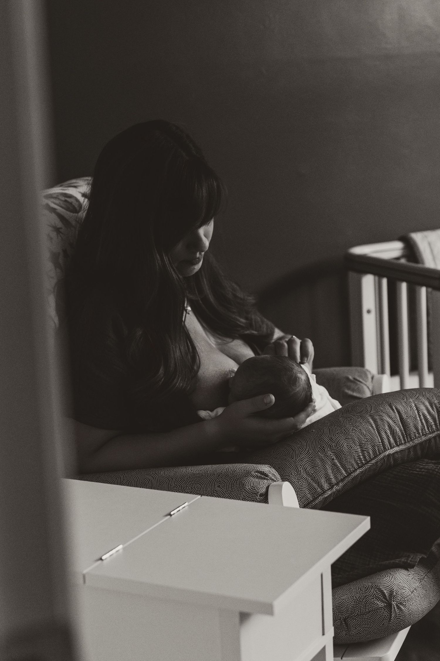 Intimate black and white photograph of quiet moments in a bedroom.