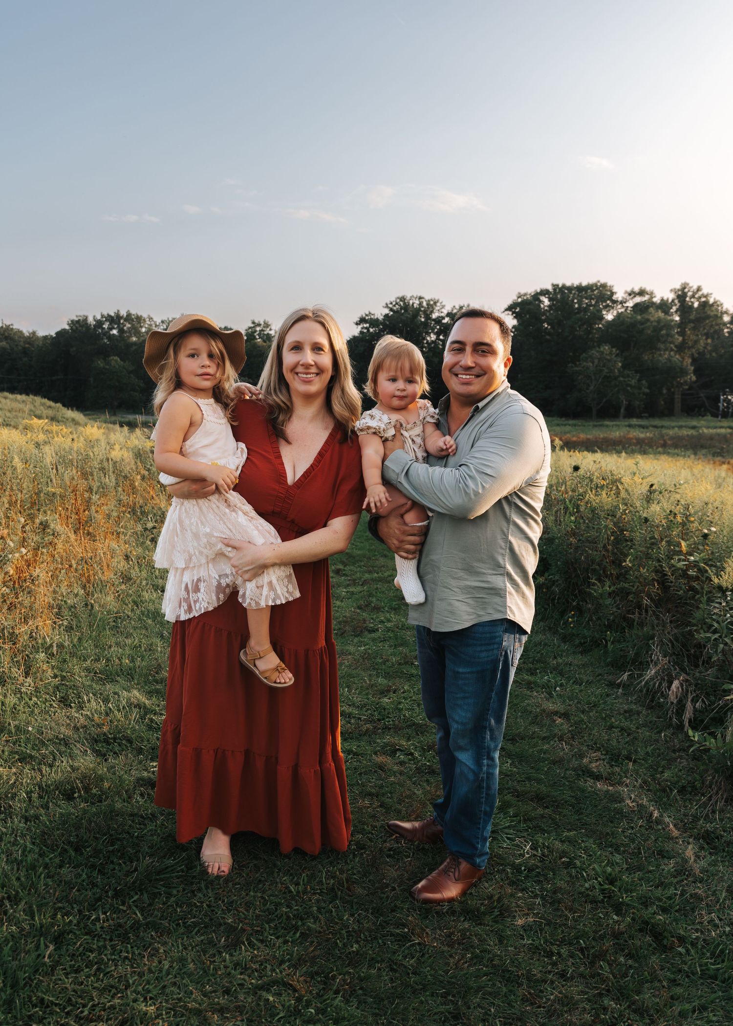 Playful family interactions in a golden field at sunset.