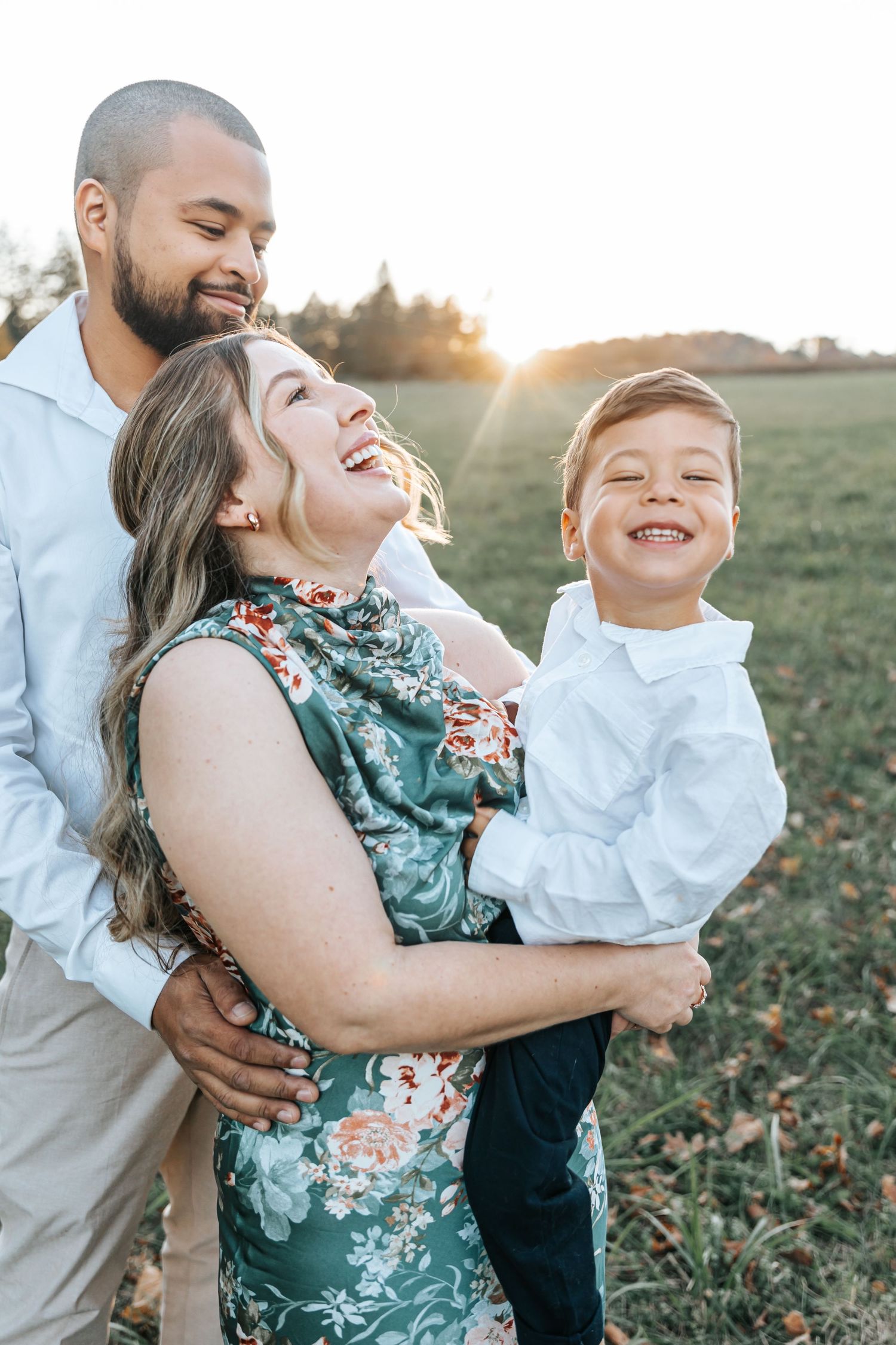 Playful family photos showing genuine laughter and joy during a sunset photo session.