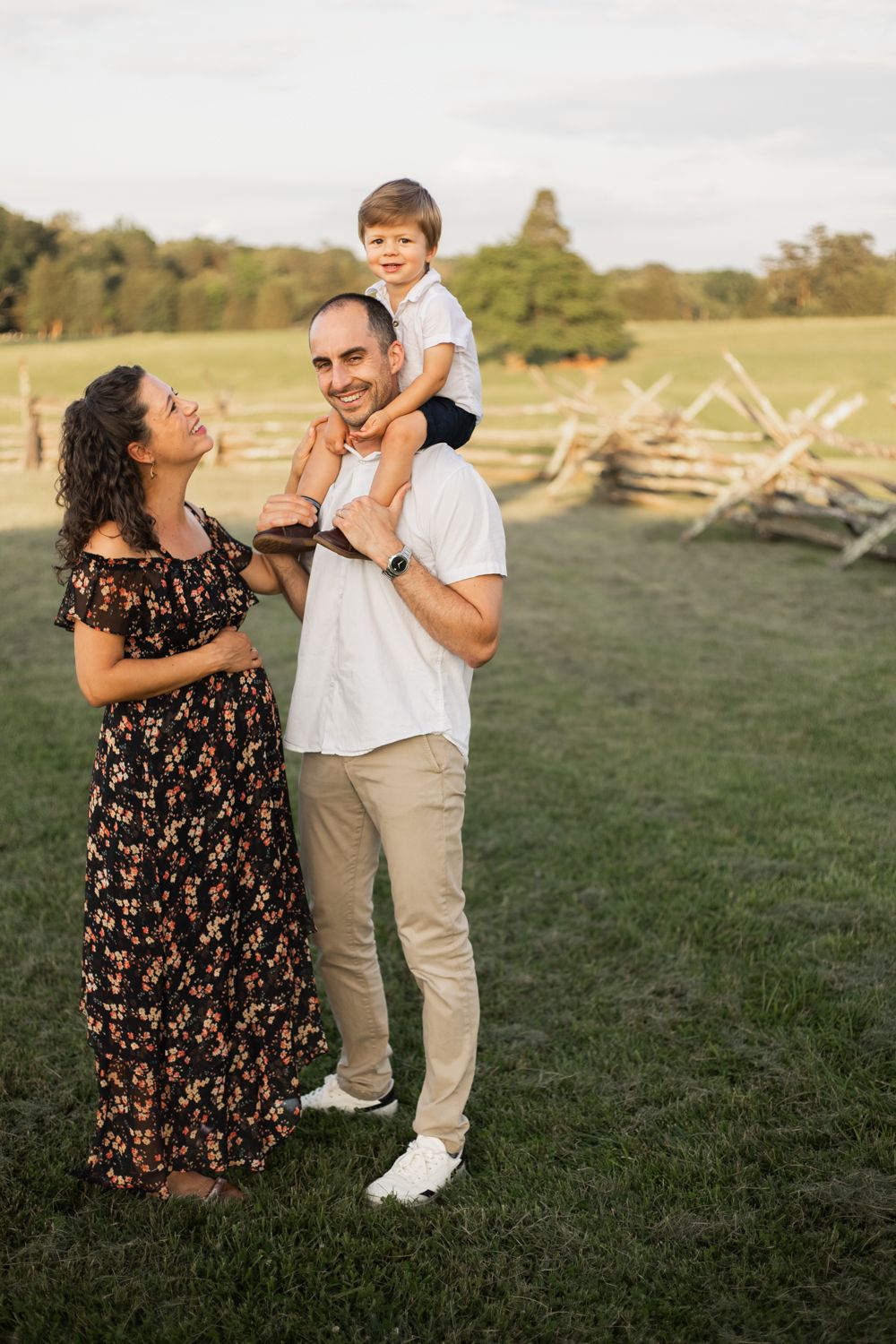 a young family smiling together during fall at manassas battlefield