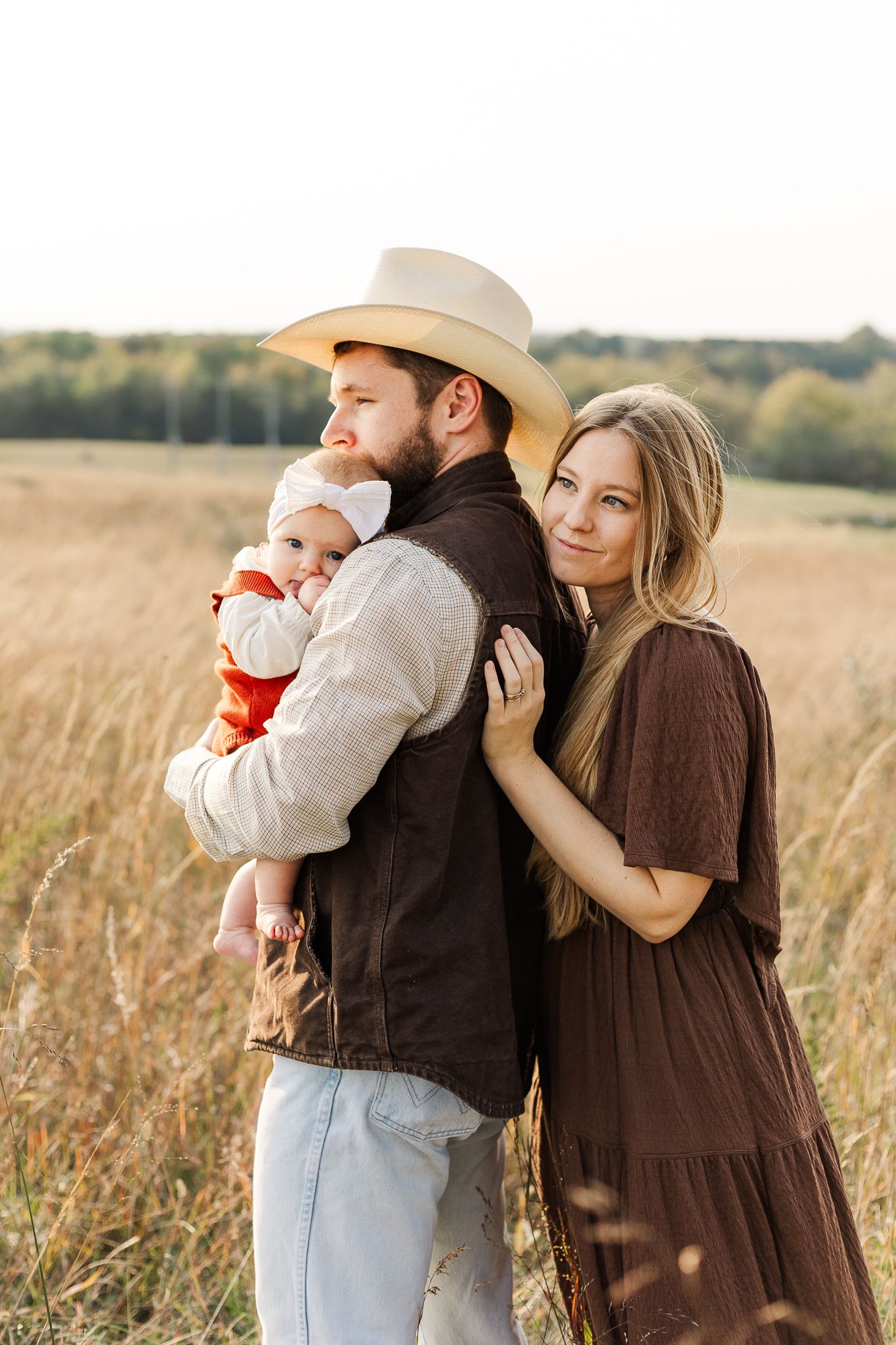 a young family smiling together during fall at manassas battlefield