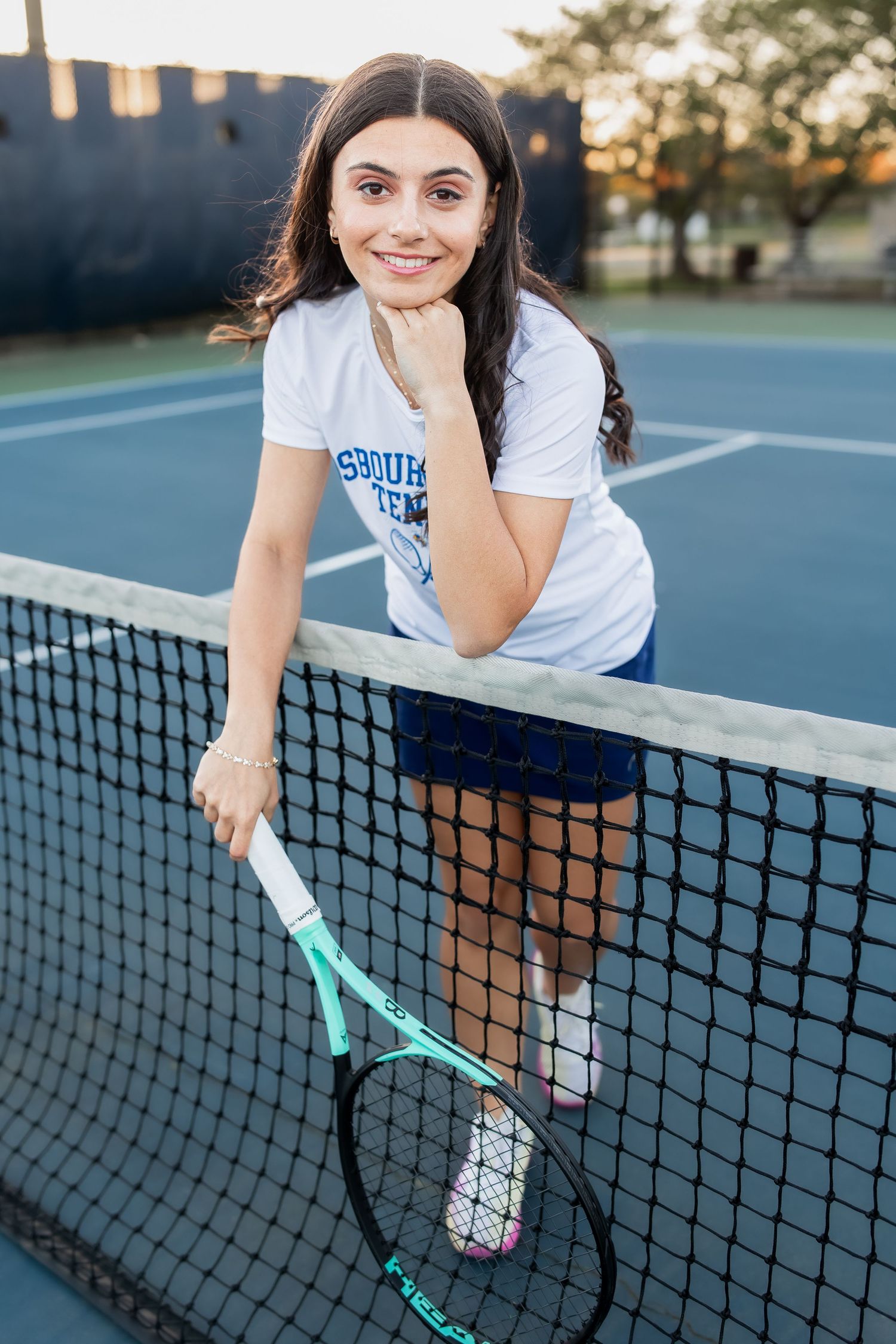 young girl smiling for graduation photos in vienna virginia