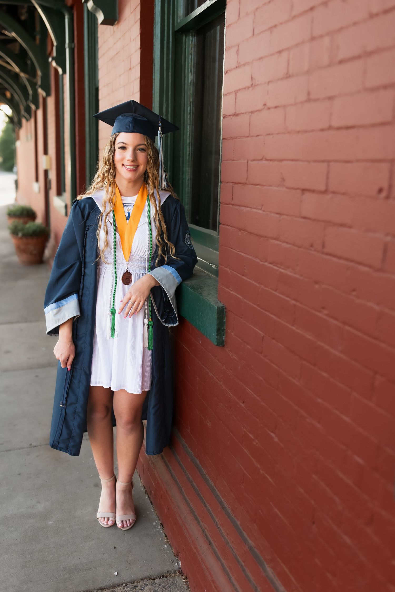 young girl smiling for graduation photos in vienna virginia