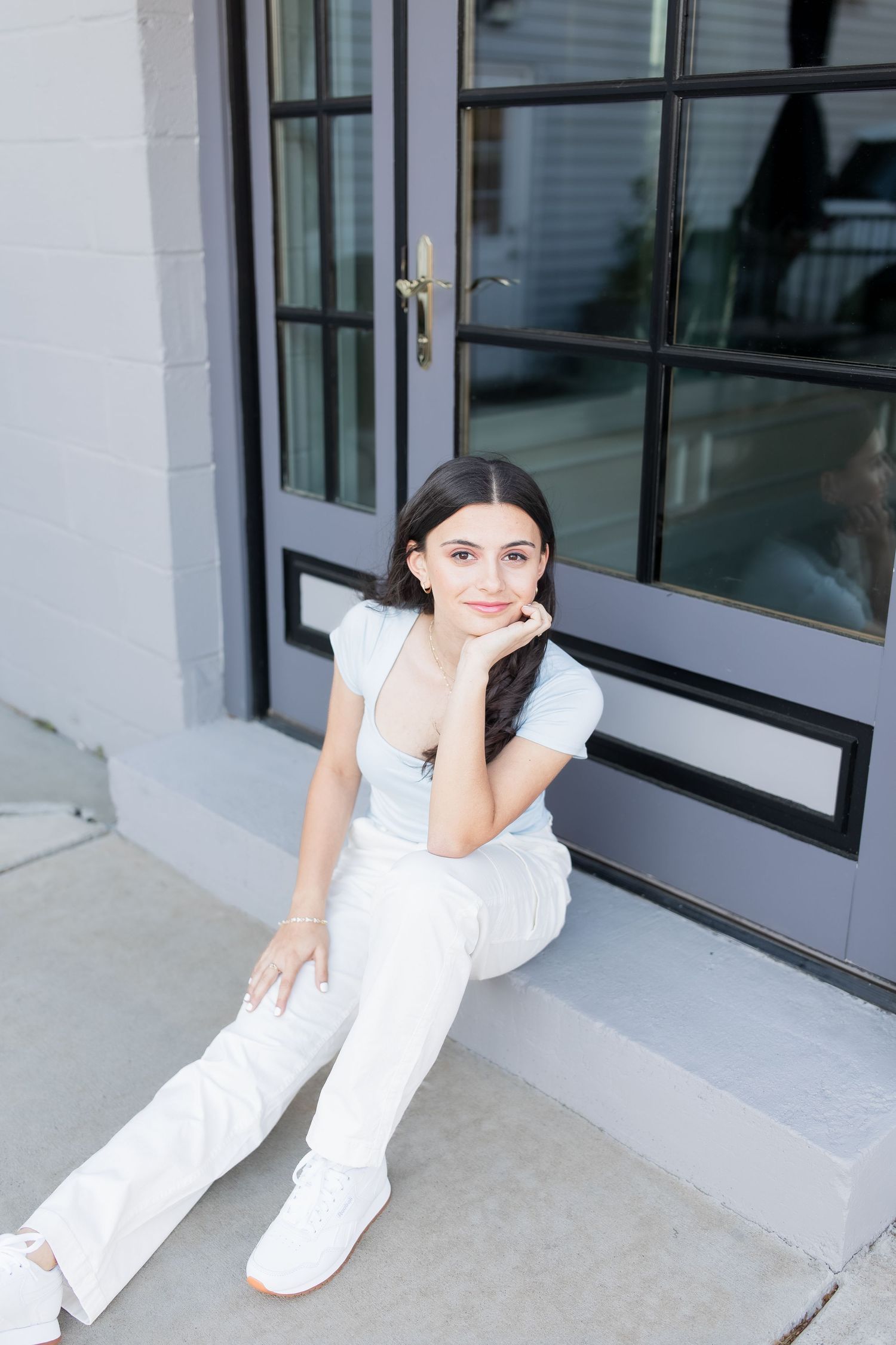 young girl smiling for graduation photos in vienna virginia