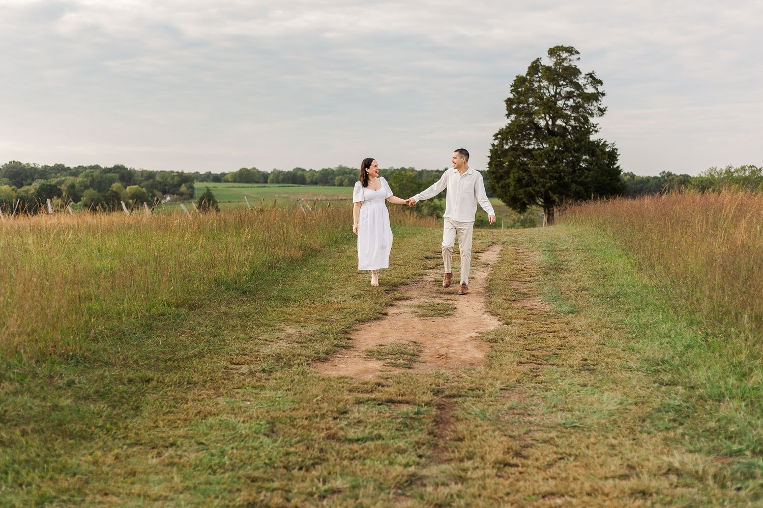 young couple smiling together during sunset at manassas battlefield