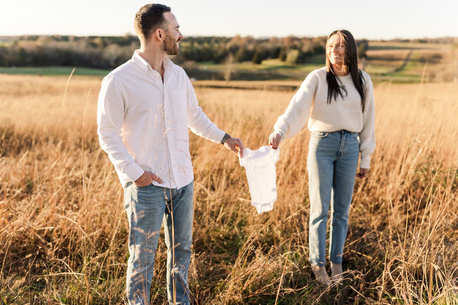 young couple smiling during the fall at sunset at the manassas battlefield northern virginia