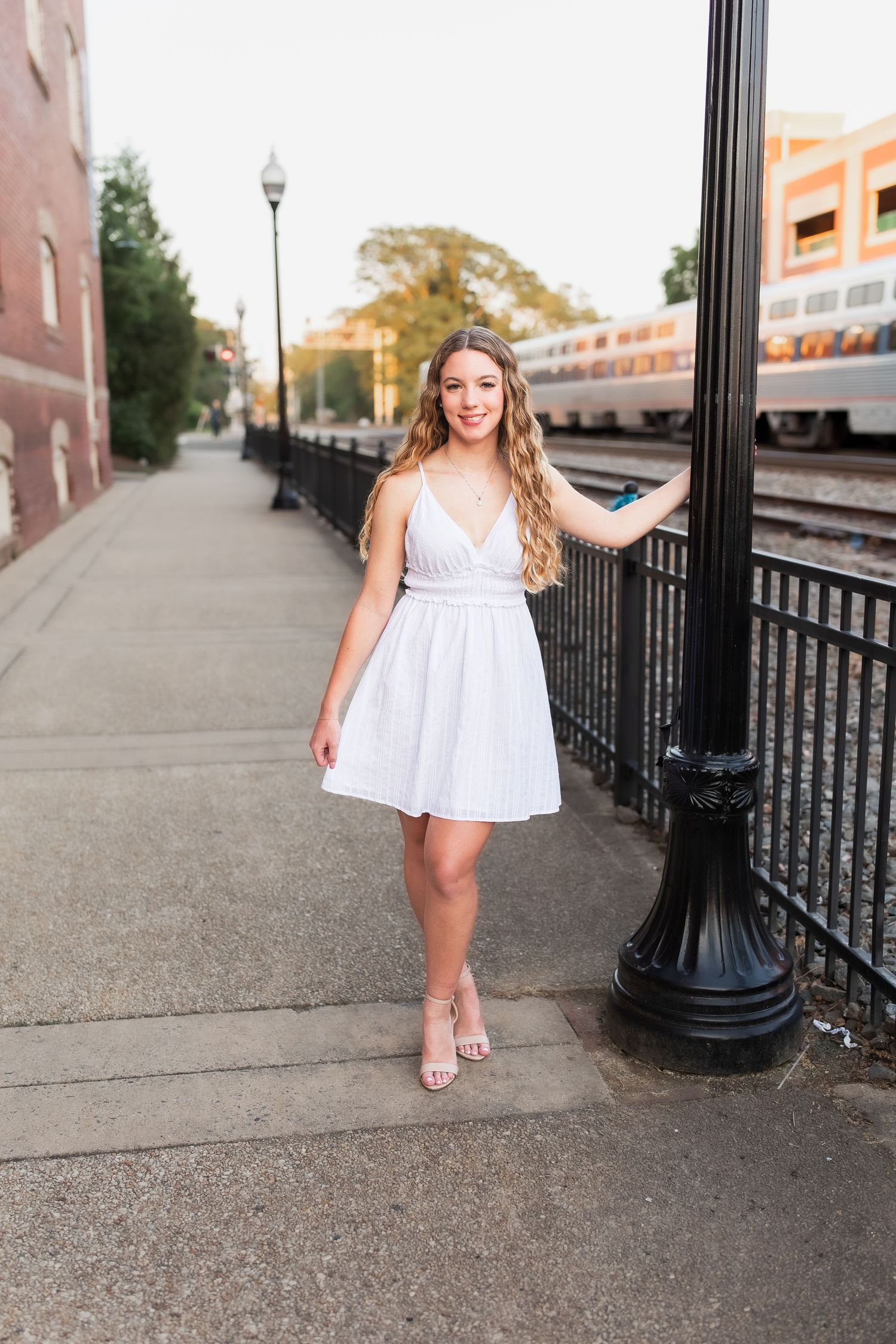 young girl smiling for graduation photos in vienna virginia