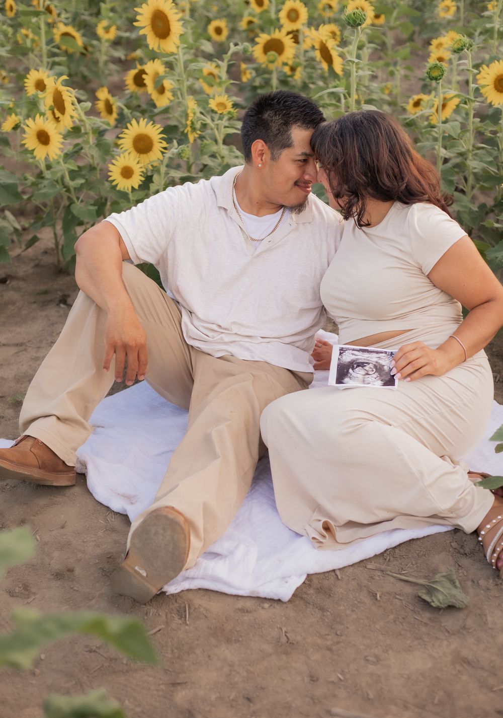 a young couple smiling at the sunflower fields of burnside farms nokesville virginia
