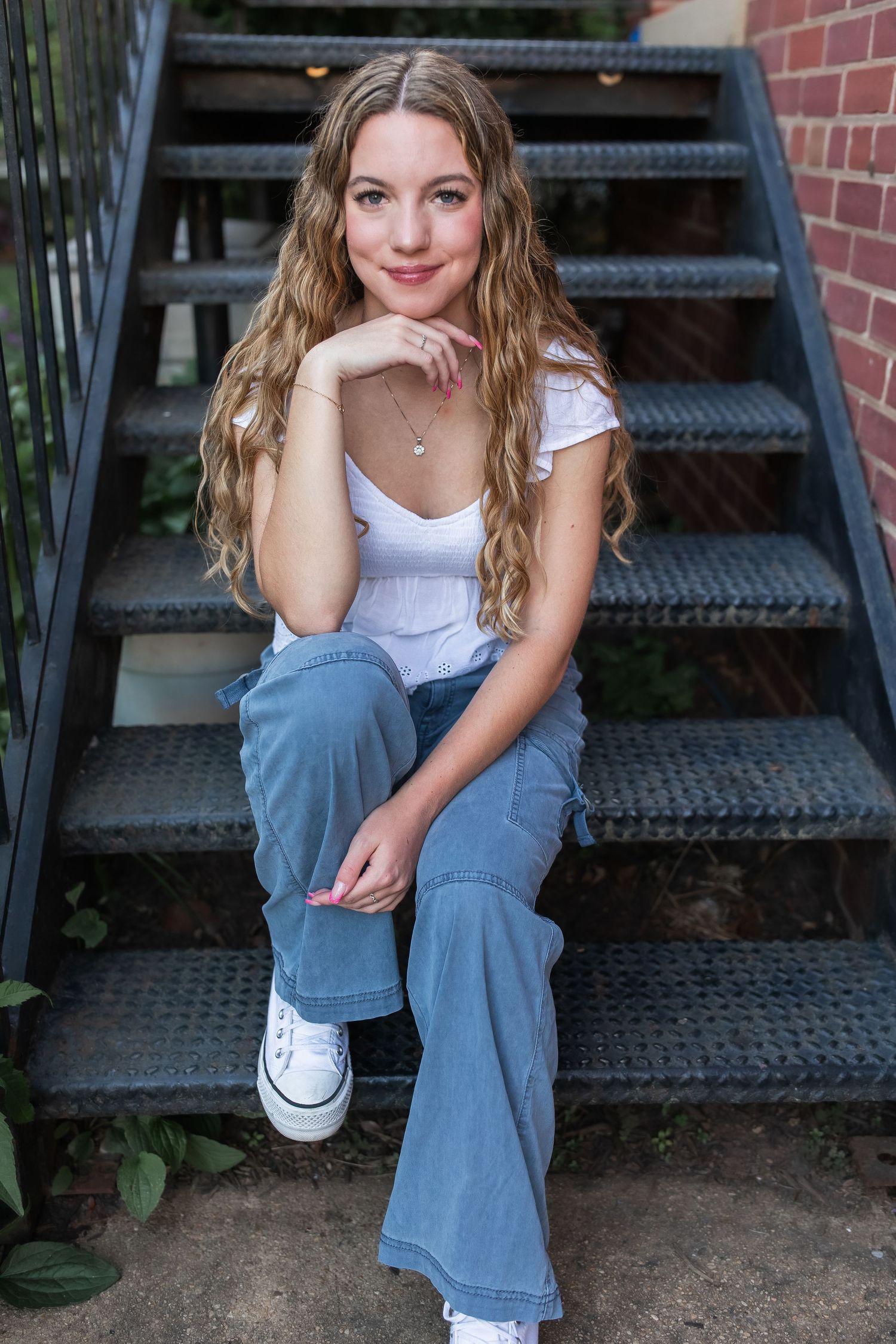 young girl smiling for graduation photos in vienna virginia