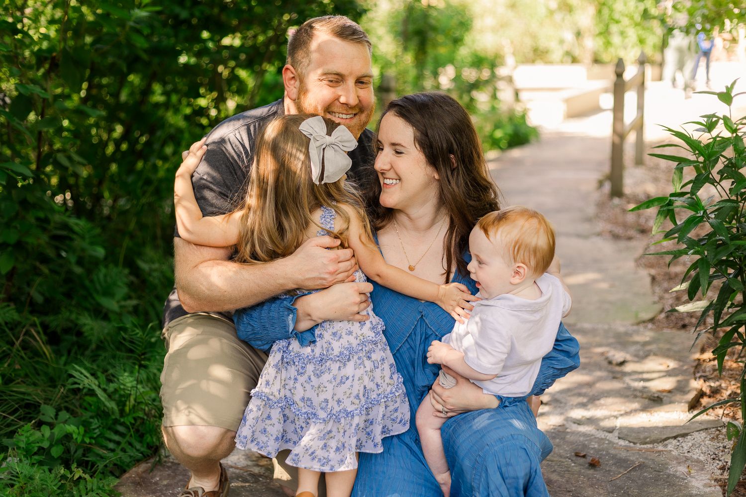 a young family smiling in a garden northern virginia