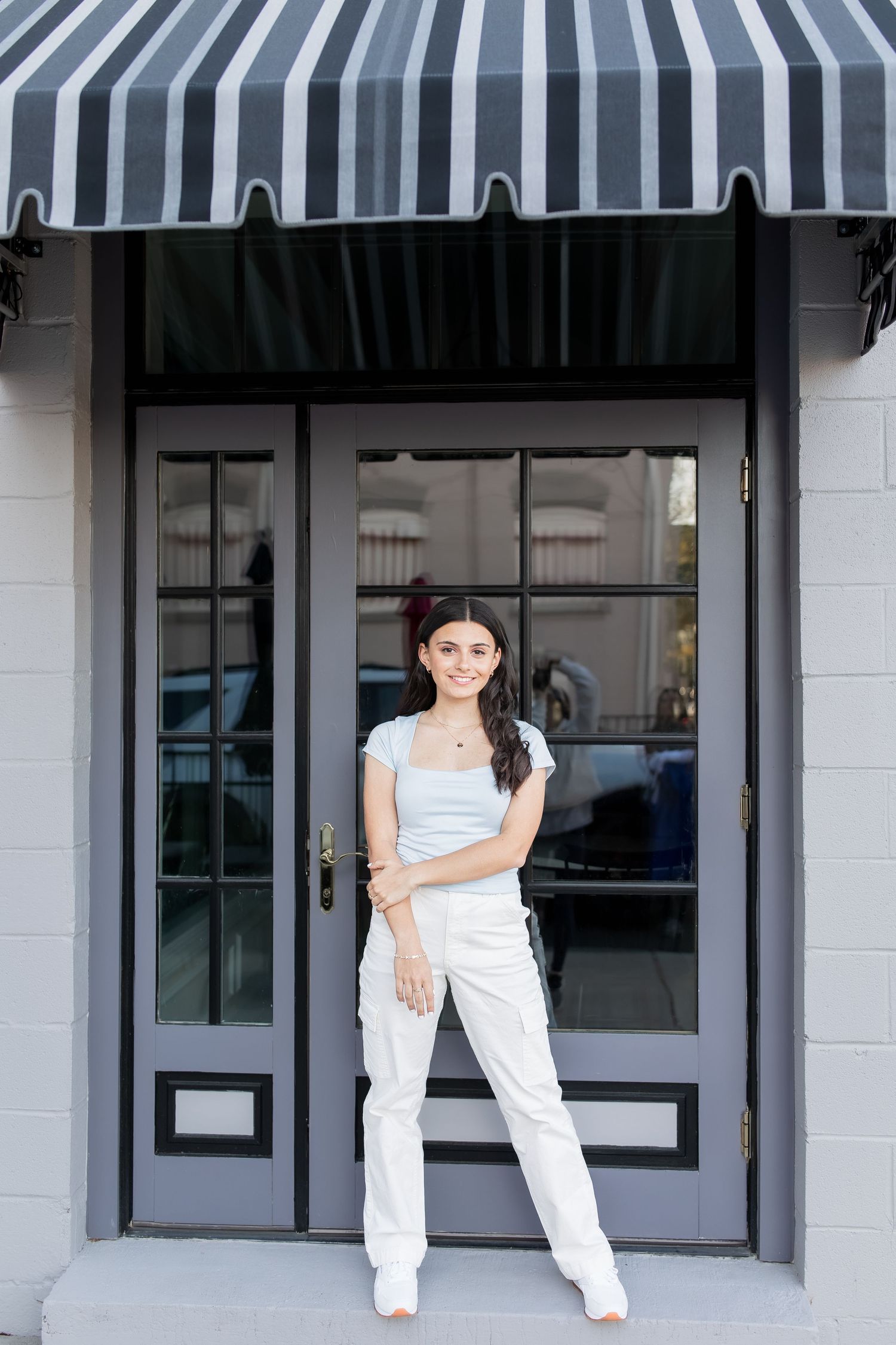 young girl smiling for graduation photos in vienna virginia