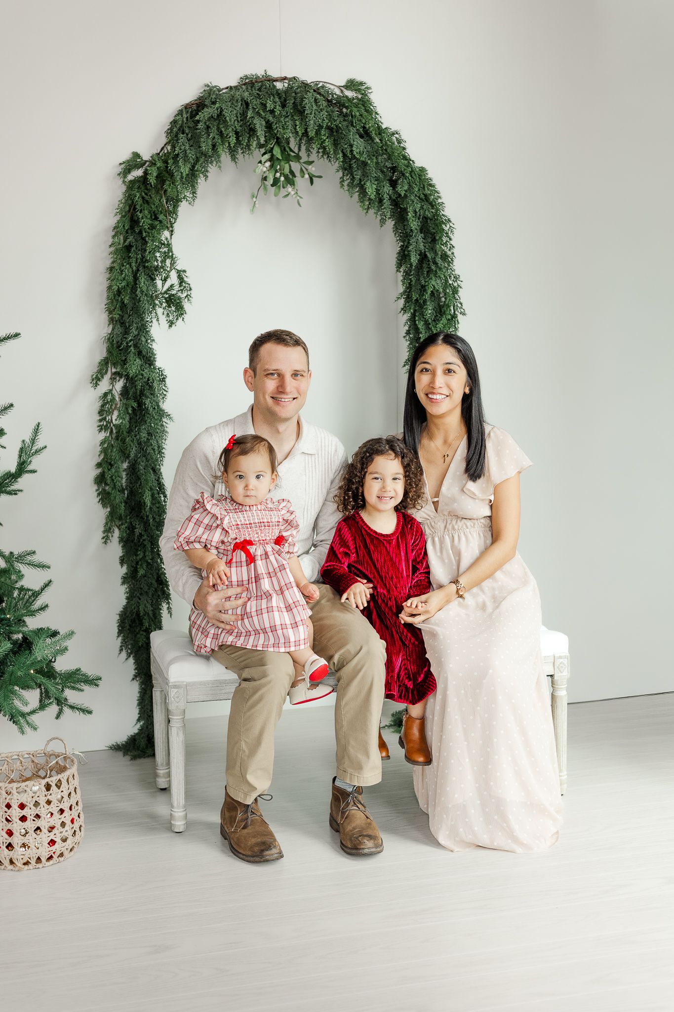 a family of four smiling at a photography studio in leesburg virginia