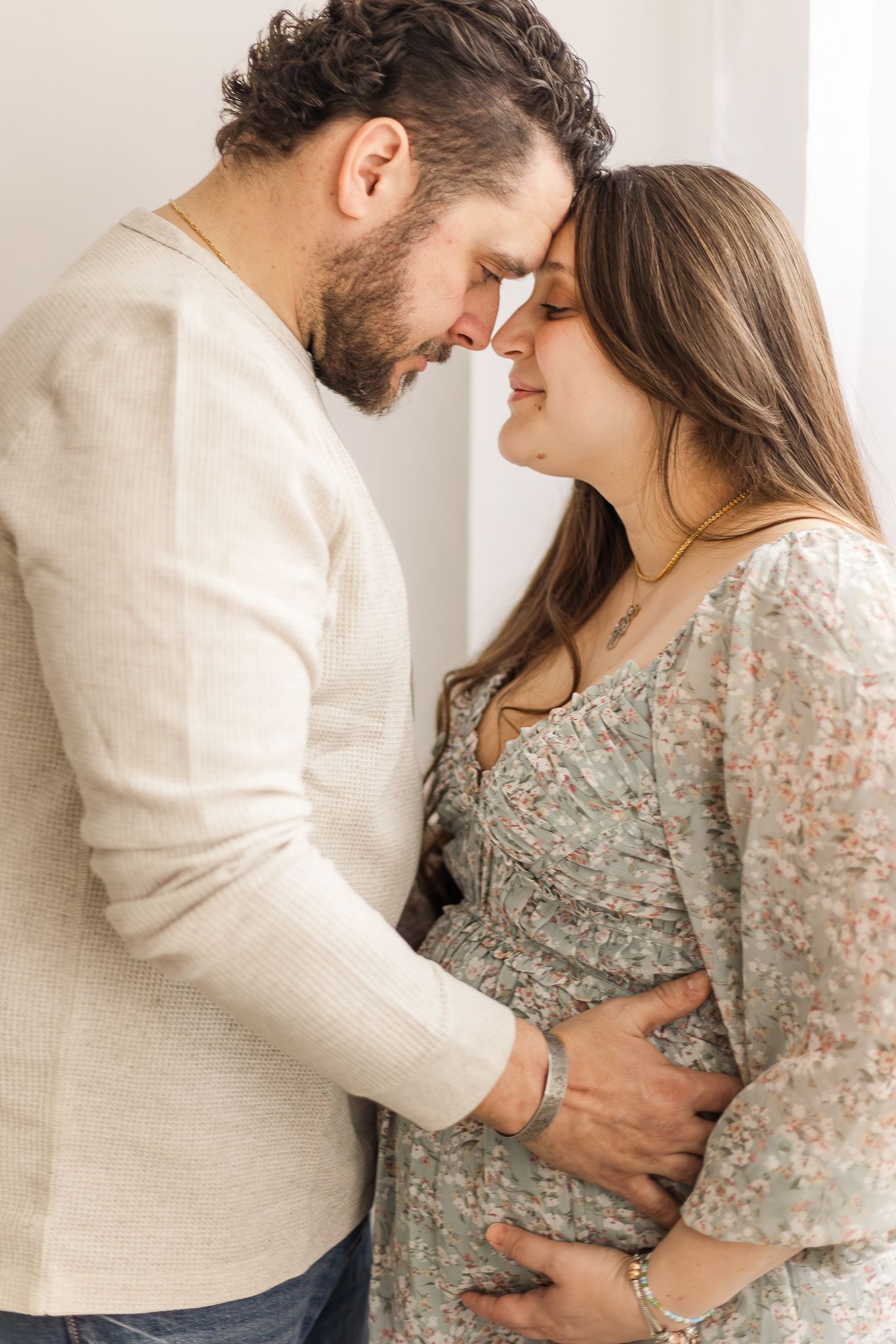 A couple smiling for studio maternity photos in leesburg, virginia