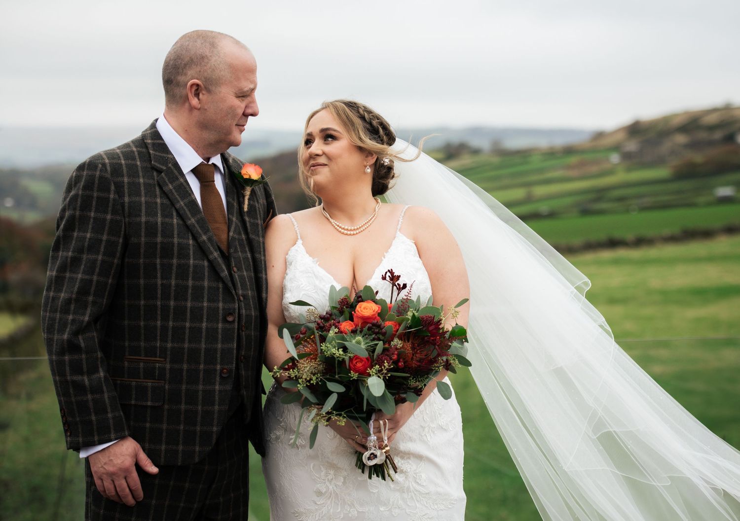 Bride and father of the bride-style shot, at The Fleece Inn, Halifax - against rolling hills and countryside landscape.