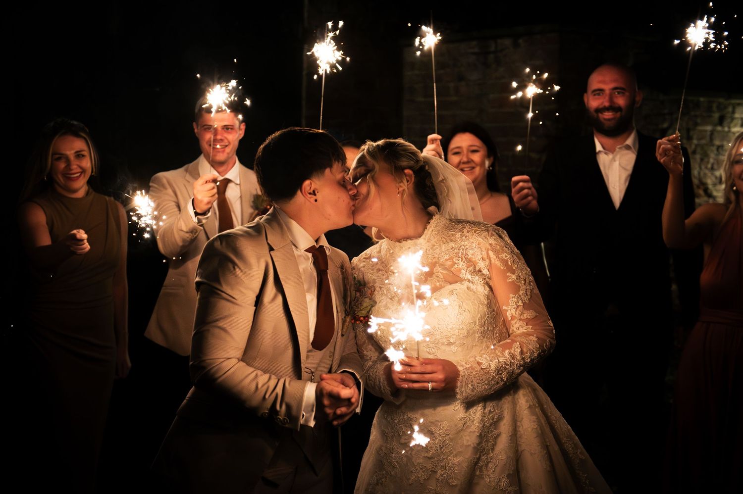 LGBT wedding celebration at night with sparklers creating a magical atmosphere around the newlyweds at Lodge Farm Weddings, Yorkshire.