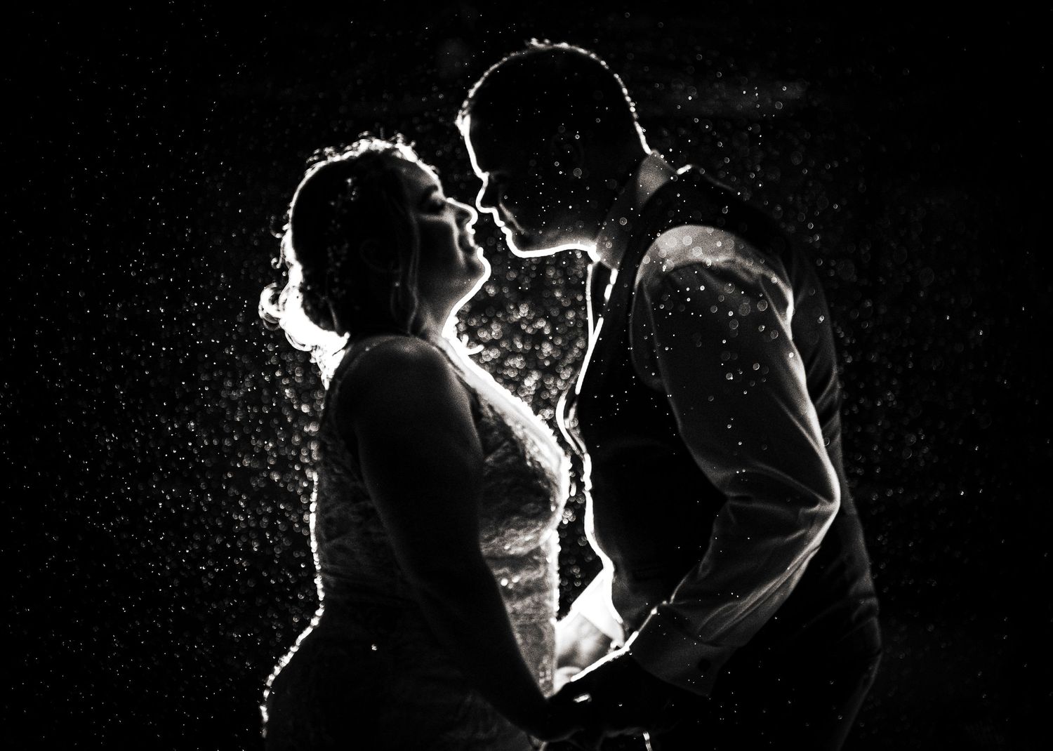 Dramatic black and white silhouette of a couple sharing an intimate moment against a dark background, at The Fleece Inn, Halifax.