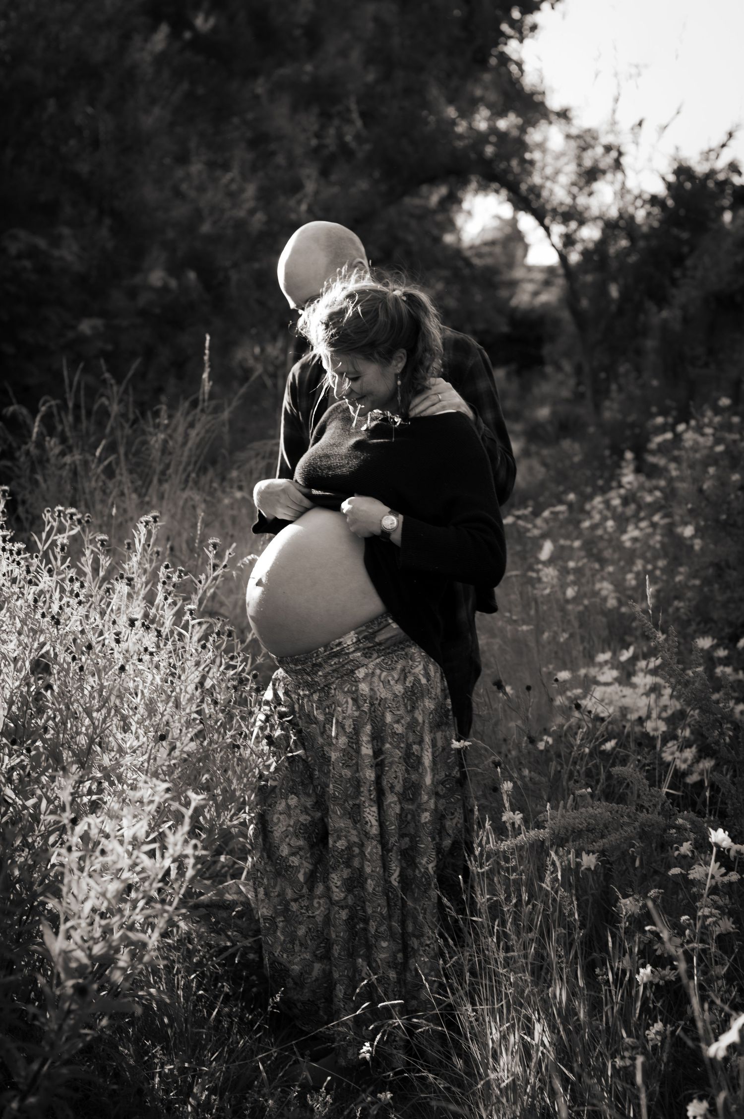 Artistic meadow portrait of a pregnant mother and her husband in Leeds, West Yorkshire.
