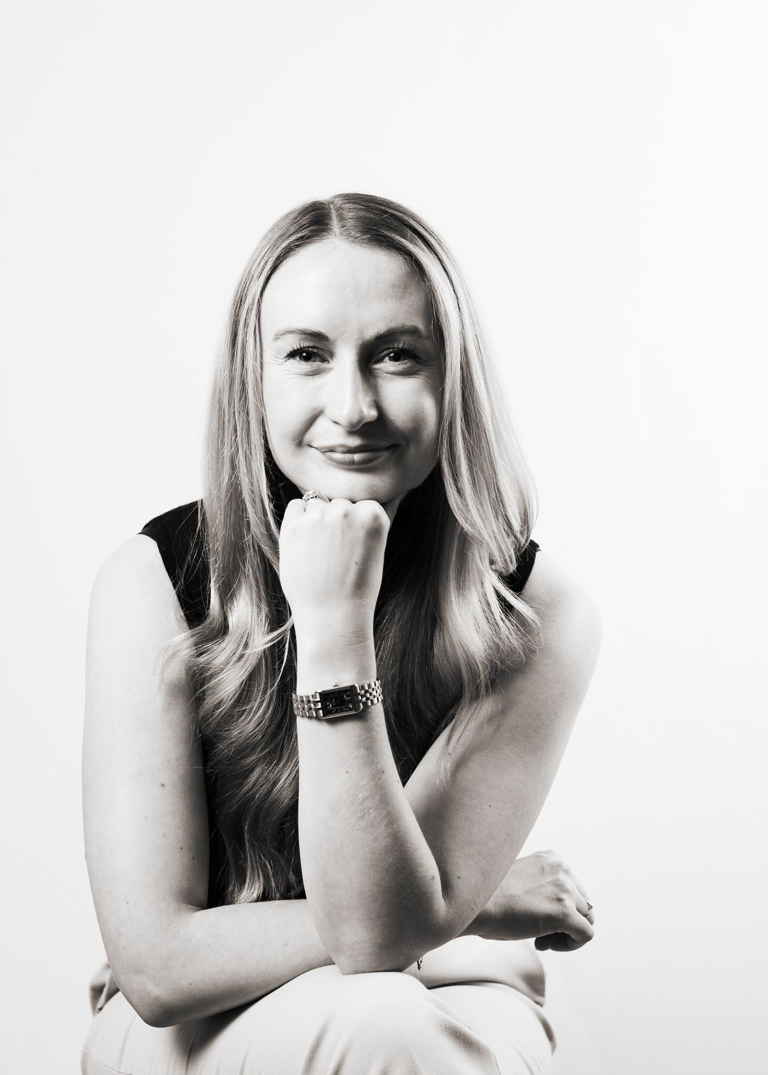 Professional studio portrait of a woman in black against white background, for her Leeds-based business.