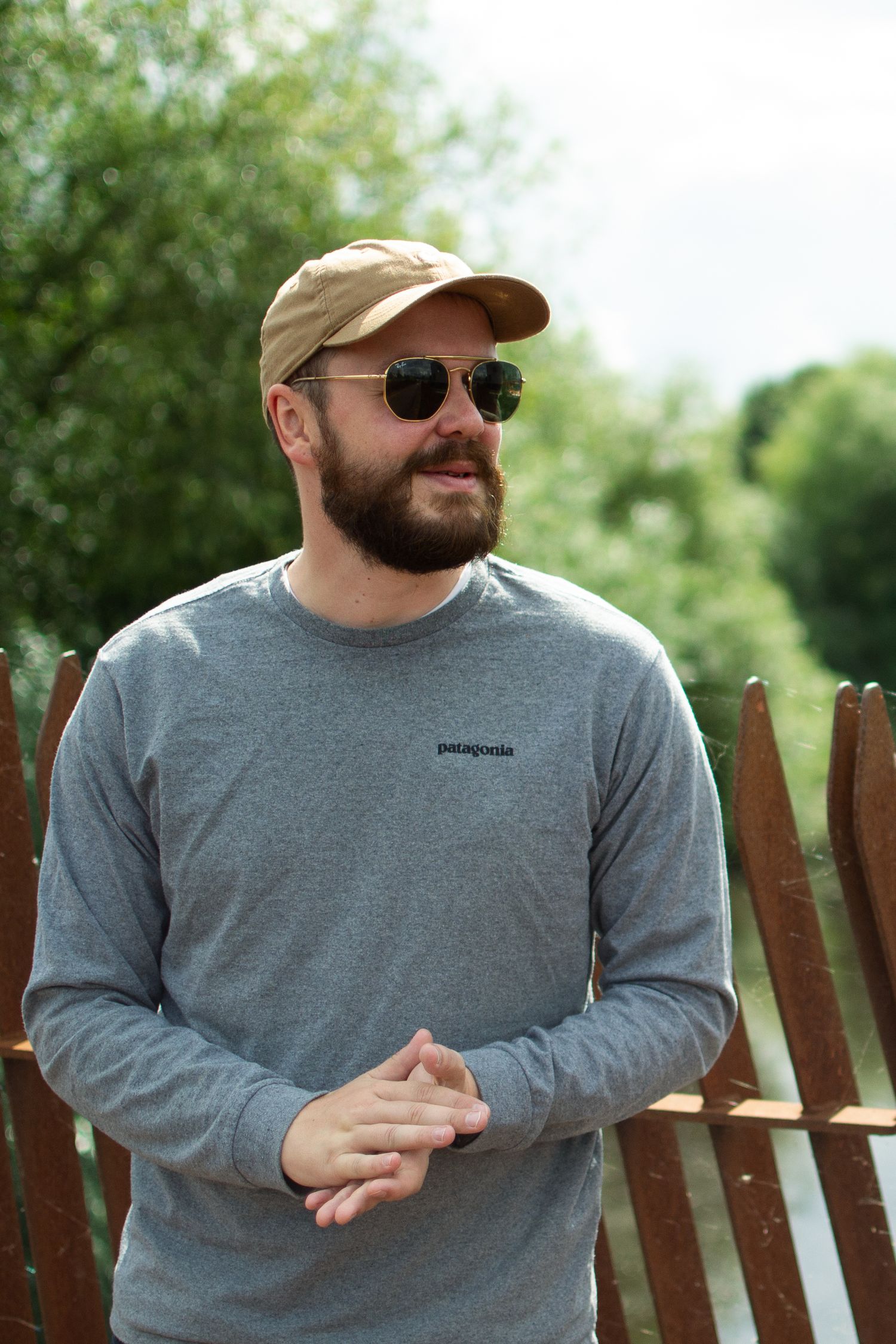 Casual outdoor business portrait in Leeds city centre of person in grey shirt and baseball cap.
