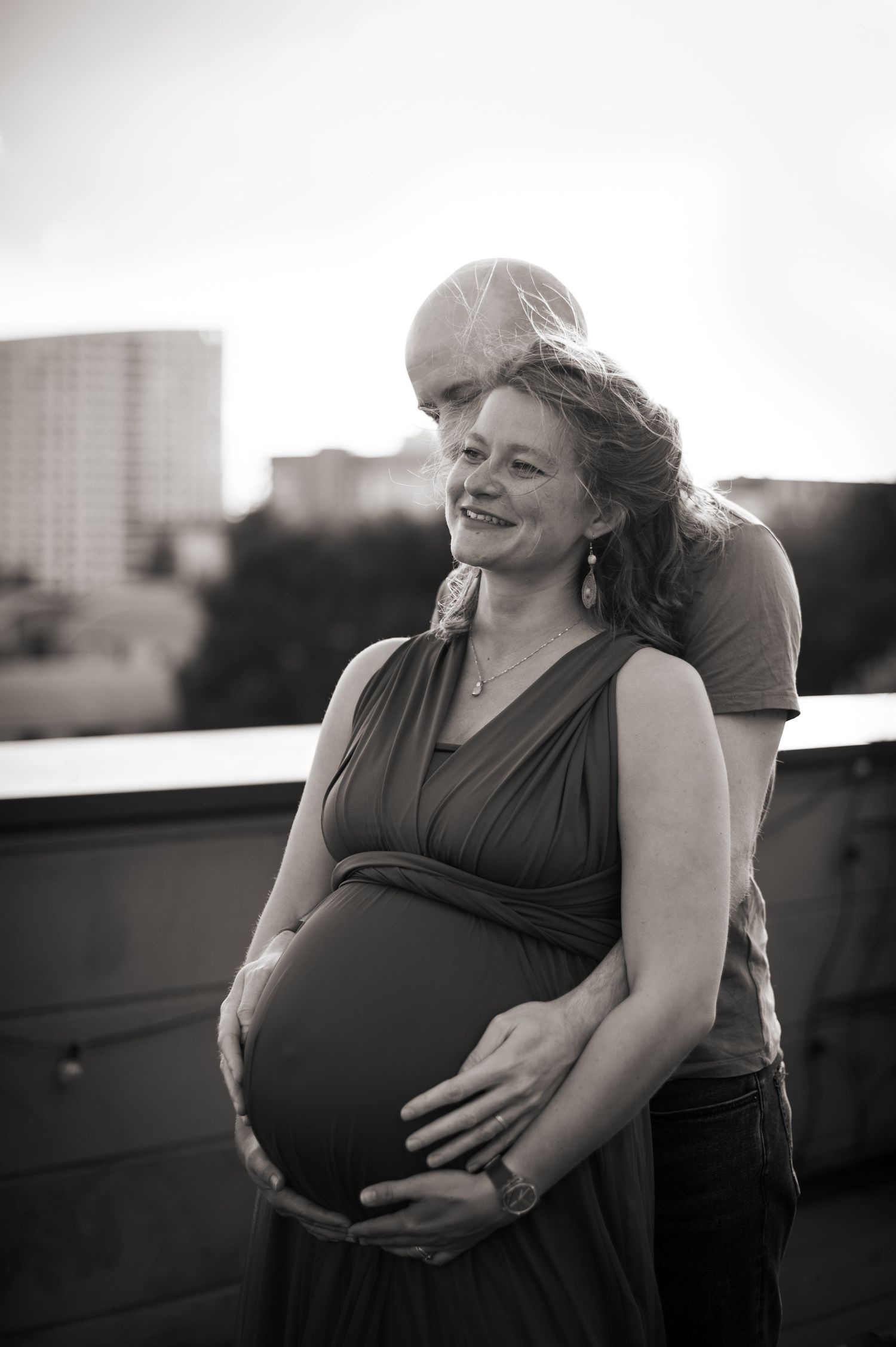 Black and white portrait of couple on a rooftop during a maternity shoot in Leeds.